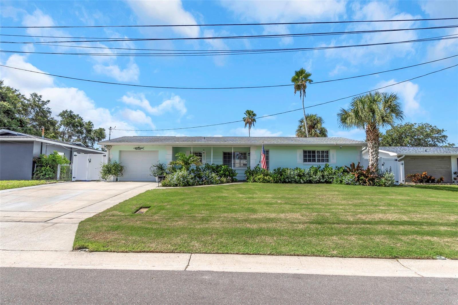 Welcome to 1071 Suemar Road, a beautifully updated single-story pool home on a quiet Dunedin street with lush tropical landscaping and a welcoming front porch. Inside, luxury vinyl plank flooring and fresh, bright finishes flow through an open living area. The kitchen offers granite countertops, plenty of wood cabinetry, and stainless steel appliances.  The primary suite is a true retreat, with an oversized custom walk-in closet leading to a spa-inspired bath featuring a freestanding soaking tub, a glass walk-in shower, and stylish shiplap walls. Two additional bedrooms each include a Murphy bed with built-in storage, so they work as guest rooms, offices, or hobby spaces. The updated guest bath and a laundry room with a built-in pet washing station add everyday convenience. Step outside to your own private resort. A large covered patio with a wood-plank ceiling overlooks a sparkling in-ground pool and an expansive, fully fenced backyard with a fire pit area, plenty of green space, and a new storage shed. Roof is 2020 and AC is 2023. All this just minutes from downtown Dunedin's restaurants and breweries, the Pinellas Trail, Honeymoon and Caladesi Islands, and the Gulf beaches. Schedule your showing today!