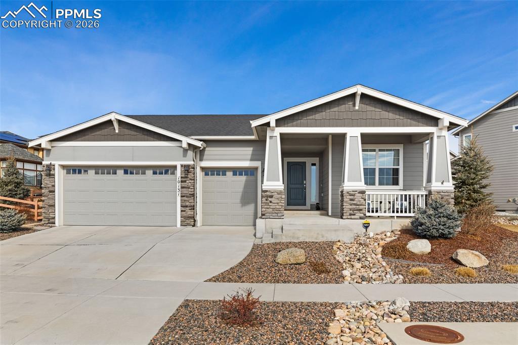 Welcome home to the beautiful rancher with views of Pikes Peak easily found from the covered front porch! This home sits on a large 0.26 acre professionally lanscaped, fenced lot in Wolf Ranch. Enjoy the Wood LVP floors throughout the main level (no carpet on the main except the primary bedroom closet!).  A front bedroom features an adjacent Full Hall Bathroom w/quartz vanity & tiled tub/shower. The kitchen is a chef's dream featuring  a large quartz island, tall soft-close cabinets and crown molding as well as a breakfast bar, walk-in pantry w/solid shelves and pull-outs, subway tile backsplash, & undermount lights. A backyard offers tranquility under the covered patio w/gas stub & privacy fence. The Great Room features a stacked stone fireplace with a mantle and a full wall of windows that fill the room with natural light. The Primary Suite provides black out shades, a large walk-in closet and adjoined spa shower bathroom with a dual sink quartz vanity, framed mirror, and a walk-in tiled shower w/built-in seat. The landry room provides access directly from the primary bathroom. A mud room offers a drop zone directly in from the 3 car garage. The basement has 9ft ceilings, a gas-log stacked stone fireplace and mantle and a quartz countertop wet bar with plenty of cabinet space and undermount lights. The basement bedrooms feature walk in closets and have east access to a full bathroom. An additional large unfinished space offers additionally flexibility to be finshed to your needs! Central air, a smart home thermostat, radon mitigation sys, & hot water recirculation system offer additional comfort as well!Enjoy walks to Wolf Lake and the Rec Center, parks, pool w/splash park, walking trails, playgrounds, a stocked lake, & summer concerts in the park. This one keeps you close to entertainment, hospitals, & shopping with easy access to the Powers Corridor, Hwy 83, & I-25 for commuting to Denver & downtown Colorado Springs!