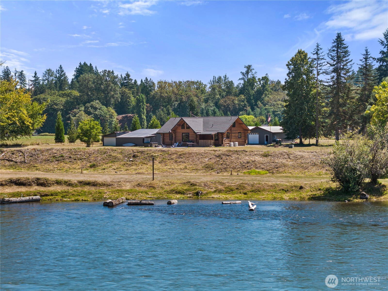 Fish at sunrise, kayak by afternoon, fire pit by sunset!! Set on 4.53 +/- acres along the Cowlitz River, this 2,066+/- sq ft log home is all about making the most of where you live. Inside, you’ll find 3-bedrooms PLUS an office, tv room, and 2-bathrooms, featuring a beautifully remodeled kitchen with newer appliances, refreshed bathrooms, new heat pumps, new roof, and a wood stove bringing that unmistakable warmth and character you want in a log home. Best of all, the scenery doesn’t stop at the windows—enjoy views of the river and, on a clear day, even a peek at the mountain! A massive 36x58 shop, additional 24x36 shop with new metal roof, & 20x30 barn give you serious space for boats, RVs, equipment, projects, hobbies, animals and whatever else comes with living life a little bigger. Outside is where weekends take on a life of their own. The inviting patio with a built-in fire pit and hot tub was made for gathering—summer evenings with friends, crisp nights soaking under the stars, and conversations around the fire that somehow last way past bedtime. Bring the fishing poles, kayaks, animals, and recreational toys, turn summer weekends into campouts, explore the acreage, or simply find your favorite spot to sit back and watch the river roll by. This is the kind of place where the fishing is close, the campfire burns late, friends want to stay awhile, and home feels a whole lot like vacation.