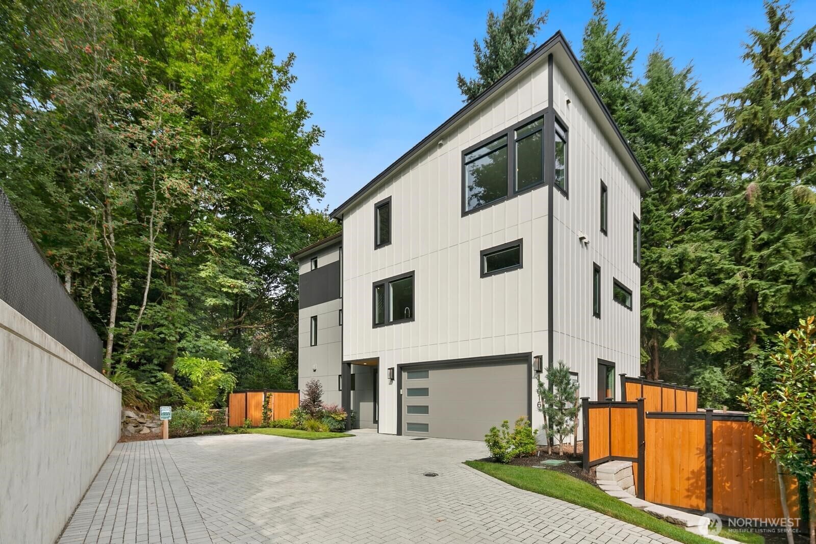 FINAL OPPORTUNITY - Conner Homes at Richards Ridge - a private enclave tucked among mature trees in Bellevue near Factoria, downtown Bellevue, and major employers. Thoughtfully designed for modern living, this move-in ready home offers exceptional flexibility with a private lower-level retreat ideal for guests, work-from-home, fitness, media, or multigenerational living. The main level is designed for entertaining with expansive windows, a dramatic tiled fireplace, gourmet kitchen with premium Wolf & SKS appliances, engineered hardwood flooring, and covered heated deck surrounded by greenery. Upstairs, the primary suite feels like a private retreat with treetop views, freestanding soaking tub, heated floors, and custom closet built-ins. Rare privacy, luxury finishes, and convenient Bellevue living. Don't miss this last chance!