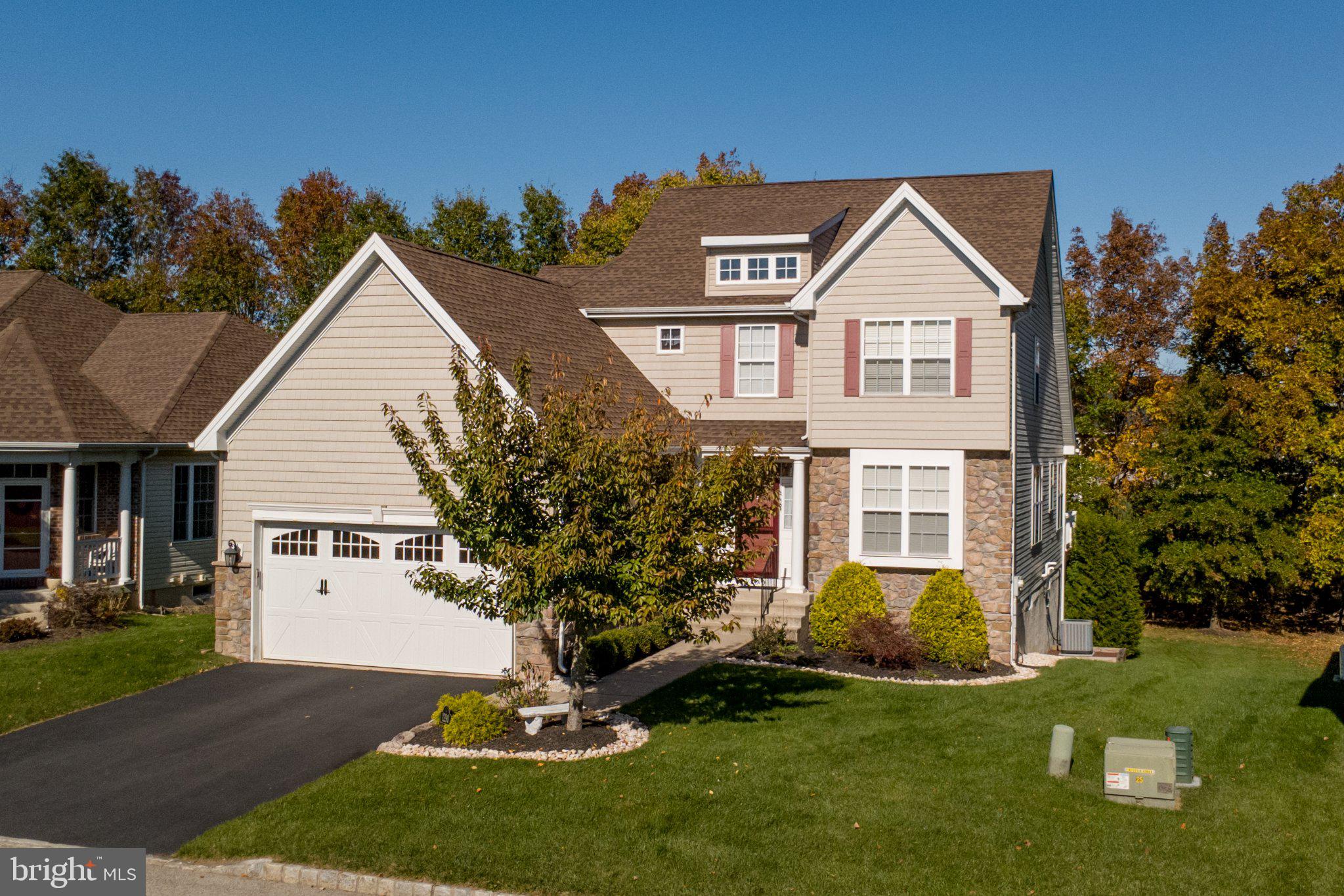 Looking for the convenience of a first-floor primary suite without giving up the space you love? Welcome to 1290 Creekside Lane, a three-bedroom home with two full and two half baths, located in the 55+ community of Renaissance at Morgan Creek in Quakertown. A two-story foyer welcomes you inside, where hardwood flooring leads past a private office with French doors and a formal dining room. Continue into the two-story living room, featuring a fireplace, a wall of windows and an overlook from the loft above. The adjoining kitchen offers an island and a bright breakfast area with access to the 14' x 10' deck, where you can enjoy the wooded backdrop with no homes directly behind you. The spacious first-floor primary suite features a tray ceiling, walk-in closet and private bath with a double vanity, soaking tub and separate shower. A powder room and laundry room complete the main level. Upstairs, the open loft provides additional space to relax, read or pursue a favorite hobby, accompanied by two bedrooms and a full bath. Need even more space? The partially finished walk-out basement includes a half bath and opens to a 20' x 12' patio, offering additional room to make your own. A two-car garage adds everyday convenience. Enjoy the amenities of Renaissance at Morgan Creek, including a clubhouse, fitness center and outdoor pool, along with a location convenient to shopping, dining and major routes. Come see all that 1290 Creekside Lane has to offer!