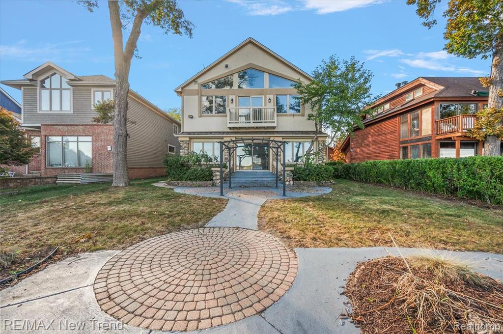 Stunning Custom Lakefront Home on Desirable All-Sports Elizabeth Lake!  Prime Location on the Lake with 50 Ft. of Sandy-Bottom Beach Frontage and Panoramic Lake Views! Home has been Remodeled in 2025 with Gorgeous Updates and High-End Details and Designer Finishes Throughout!  Approx. 3,000 Sq. Ft with Open Concept Design Blended with Modern Elegance! Home Features  4 Bedrooms, 3 and Half Baths with Lake Views from Multiple Rooms!  Luxurious Gourmet Chef's Kitchen Featuring Premium Italian Appliances, Quartz Countertops, and Custom Cabinetry with Soft-Close Drawers, Huge Center Island with  2 Stainless Sinks.  2 Stainless Refrigerators, Microwave, and 2 Built-in Wine Coolers.  Fireplace with Quartz Surround in Kitchen and Family Room Area! Luxurious High-End Wood Style Flooring and Recessed Lights!  Living Room or Potential 1st Floor Bedroom with adjoining Full Bath on Entry Level. Spacious Primary Bedroom with High Vaulted Ceiling, 2 Huge Walk-In Closets, Fireplace, and Private Lakeside Deck with Fabulous Views!  Luxurious Modern Primary Bathroom with Custom Steam Shower, Vanities with Quartz Countertops and Huge Jacuzzi Tub. 2 Additional Large Bedrooms on Upper Level with High Vaulted Ceilings with Skylight, Large Walk-In Closets and a Full Bath.  2nd Floor Laundry for added convenience. This home is Move-In Ready.  New B-Dry Waterproof System (2025) in Basement with Lifetime Warranty that is transferable to the new owner.  Beautiful Outdoor Patio with Pergola and Gorgeous Backyard and Sandy-Bottomed Waterfront!   2 Car Detached Garage.  Large common area parcel located across the street is owned by the homeowners on this street and provides a park-like setting.  Enjoy the Finest in Lakefront Living on All-Sports Elizabeth Lake!  All M & D Approx.