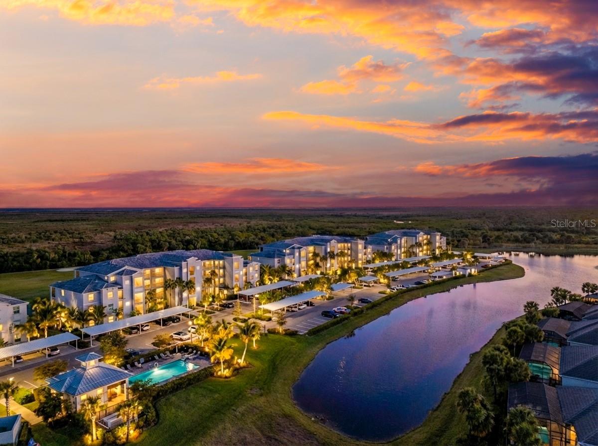 One or more photo(s) has been virtually staged. Enjoy effortless Florida living in this ground-floor Arbor condo in Heritage Landing, complete with a deeded golf membership. With no elevator to navigate, daily life is easy—whether you’re carrying in groceries or stepping right outside from your patio to take in the peaceful panoramic golf course and lake views. The open-concept layout is great for entertaining, with a large, flush-level breakfast bar that seamlessly connects the kitchen to the living and dining areas. The kitchen features stone countertops, stainless steel appliances, and a layout that keeps you connected to the main living space. Tile flooring throughout the main living areas adds durability and a clean, coastal feel.  Striking views extend into the primary suite, creating a serene retreat. The primary bath includes dual closets, a stone-topped vanity, and a walk-in tiled shower, offering both function and style. Peace of mind comes with impact doors and windows plus NEW ROOFS COMING IN 2026 with no assessment per the condo association, adding long-term value and confidence in ownership.Heritage Landing is known for its resort-style amenities, including a championship golf course, expansive clubhouse, resort pool with lap lanes, fitness center, spa services, tennis, pickleball, and bocce courts, multiple dining options, and a full calendar of social activities—making it easy to stay active and connected year-round.