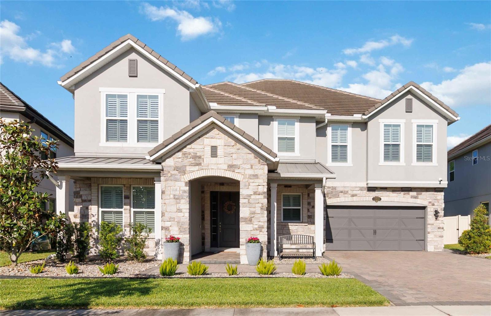 Assumable VA Loan at 2.75% interest! Step into luxury in this impeccably designed home, filled with high-end upgrades and smart home features.

From the moment you arrive, the extended paver driveway, stone façade, and manicured landscaping set the stage for quality craftsmanship and stunning curb appeal. A welcoming front porch invites you in with charm and warmth.

Located in the gated community of Belle Vie in Lake Nona, this home sits on just under a quarter-acre conservation lot, offering both privacy and peaceful natural views. Enjoy peace of mind with wired exterior cameras, a fenced backyard, a hurricane-rated garage door, Lorex smart doorbell, and a Rain Bird irrigation system keeping your home secure, private, and lush.

Inside, the gourmet kitchen is a chef’s dream. Outfitted with KitchenAid appliances, a farmhouse sink, quartz countertops, convection wall oven and microwave, vented range hood, custom tile backsplash, under-cabinet lighting, and a butler’s pantry with a beverage fridge, it blends beauty with function.

The home’s interior shines with engineered hardwood floors, plantation shutters, and crown molding in the office, dining room, and owner’s suite. A glass-enclosed office offers a bright, modern workspace with quiet seclusion—perfect for working from home.

The main-level owner’s suite is a tranquil retreat featuring custom wood doors, built-in closet shelving, and luxurious comfort. Upstairs, a private en-suite bedroom is perfect for guests or multigenerational living.

Entertainment is elevated in the dedicated theater room, complete with a surround sound system and elevated seating riser for a true cinematic experience.

Efficiency and connectivity shine with two Carrier A/C units, Nest thermostats, a hybrid water heater, water softener, and a built-in On-Q® Smart Home Hub.

Additional highlights include a coated garage floor, keypad garage entry, a laundry room with utility sink and upper cabinets, and thoughtfully placed power outlets in the pantry, closets, and linen storage areas for added convenience.

Washer and dryer, bench, and tall planters in the front yard convey with the sale.

Please note: Interior cameras and floor-mounted garage shelving do not convey.

This home offers the perfect blend of luxury, comfort, smart living, and thoughtful detail—truly a one-of-a-kind property in a prime location. Don’t miss the opportunity to make it yours. Schedule your private showing today!