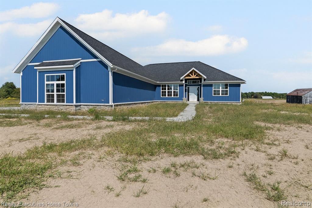 This stunning new split ranch combines modern luxury with country tranquility, set on 5 private acres in China Township. A 3-car side-entry garage adds both convenience and curb appeal. Inside, the open floor plan is ideal for everyday living and entertaining, featuring a stylish kitchen with hardwood floors, white Lafata cabinetry, and a large quartz island ready for your entertaining needs. The kitchen flows seamlessly into the great room, where a floor-to-ceiling tiled accent wall with an electric fireplace creates a warm and inviting centerpiece.
The primary suite is a true retreat with a spa-inspired bath that includes double sinks, quartz countertops, and an oversized tiled shower with a rain head, dual shower heads, and a built-in bench. A spacious walk-in closet provides abundant storage. The mudroom offers custom built-ins, while the full basement is ready to be finished to suit your needs. Step outside to relax and entertain on the covered back deck, perfect for enjoying the beauty of the property year-round.
Blending style, comfort, and function, this remarkable home is an opportunity you won’t want to miss.