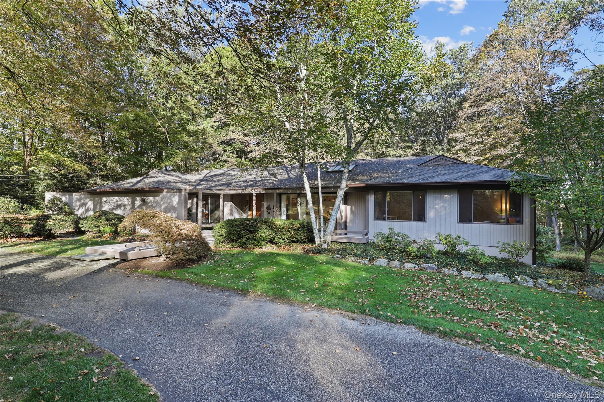 First time on market! This meticulously maintained 4-bedroom Mid-Century Modern Ranch sits at the end of a quiet cul-de-sac in a highly sought-after neighborhood within the award-winning Byram Hills School District. Exceptional design, abundant natural light and seamless indoor-outdoor flow define this special home. The functional open layout is ideal for both everyday living and effortless entertaining, with expansive windows and numerous skylights elegantly merging the home’s interior with nature’s beauty. A unique covered front entry and two-tier deck enhance the home’s architectural appeal and reinforce the home’s connection to nature. A flat and private backyard framed by mature trees is ideal for play, relaxation, and gatherings. An updated kitchen and primary bath; custom lighting, built-ins and shelving; plus an impressive courtyard-style driveway further add to this home’s modern appeal. The fully finished walk-out lower level offers versatile living space plus significant storage. New roof and gutters (2023). Low taxes. Conveniently located near Byram Hills schools, downtown Armonk's gourmet dining and boutique shops, North White Plains Metro-North station and less than 45 minutes to Manhattan via car—don’t miss this one-of-a-kind gem!
