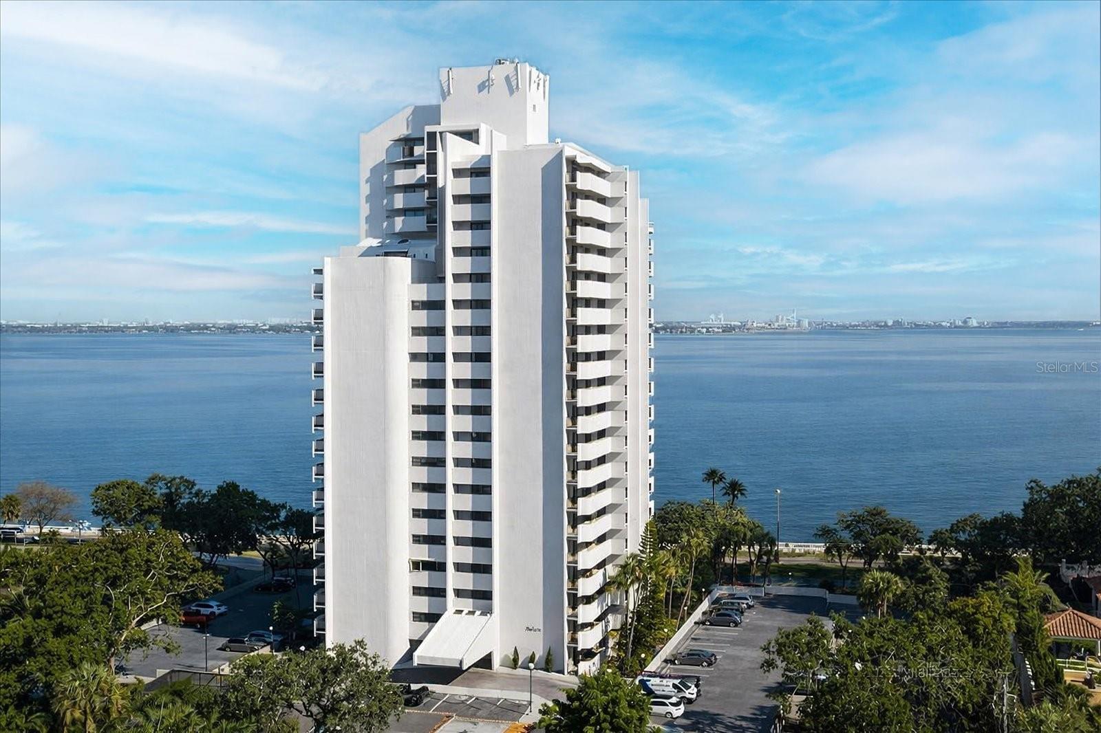 Penthouse living on iconic Bayshore Boulevard with breathtaking panoramic views of Tampa Bay and the downtown skyline. This fully renovated 2-bedroom, 3-bath residence offers rare east, north, and west exposures, allowing you to enjoy both sunrise and sunset from three private balconies.Thoughtfully redesigned in 2017, the home features a warm coastal aesthetic with high-end finishes throughout, including quartz countertops, an Italian marble backsplash, and premium appliances. The kitchen is both stylish and functional, perfect for everyday living and entertaining. Flooring was updated in 2023, and the A/C was replaced in 2021.A versatile bonus room provides the ideal space for a home office, studio, or potential third bedroom conversion. The penthouse location offers enhanced privacy and security with private elevator access.Residents enjoy a full-service lifestyle with resort-style amenities, including a waterfront pool, fitness center with sauna, community room, guest suites, on-site management, and security. The unit also includes three assigned parking spaces two in the garage and one outdoor an exceptional offering along Bayshore.Located directly on Bayshore Boulevard, enjoy miles of scenic waterfront walking and biking paths just outside your door.