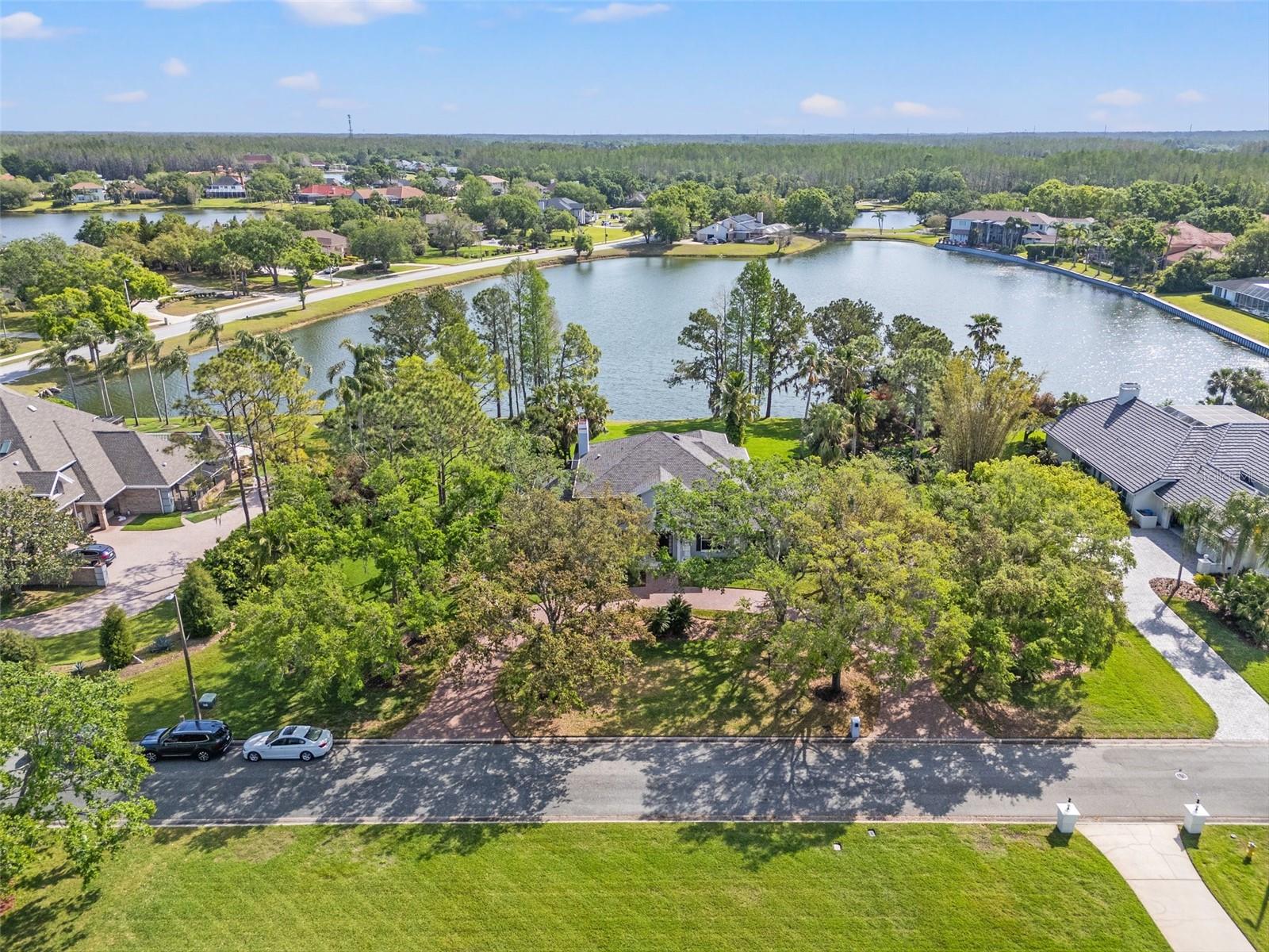 One of THE BEST lots in Cheval! This exquisite home, nestled on just under an acre in the distinguished Estates of Cheval, offers an unparalleled living experience. Meticulously renovated in 2022–2023 with no detail overlooked, this custom-built home features 5 bedrooms, 4.5 bathrooms, and a dedicated office/media room across 4,157 square feet of luxurious living space. As you arrive, a circular pavered driveway and fresh landscaping welcome you, setting the stage for what lies ahead. Inside, soaring ceilings and a sweeping staircase frame breathtaking panoramic views of the pool and serene lake beyond. To the left, the versatile media room easily doubles as an office, gym, or hobby space, while the formal dining room to the right with elegant wainscoting creates a refined setting for entertaining. The great room boasts custom built-ins, a cozy fireplace, and French doors that open to the screened-in pool area with a covered outdoor kitchen, perfect for hosting or unwinding. The fully updated gourmet kitchen (2023) showcases GE Monogram appliances, quartz countertops, a spacious island, and a walk-in pantry, complemented by a breakfast nook with peaceful lake views. A private guest suite with its own bath completes the first floor.  Upstairs, the primary suite offers lakefront tranquility with a separate office/sitting area, two walk-in closets, and a spa-inspired bath featuring a soaking tub, quartz dual vanities, and a walk-in shower. Three additional en suite bedrooms ensure every family member or guest enjoys privacy.  Step outside to your private oasis: a sparkling pool, expansive screened lanai, covered outdoor kitchen, and lush .92-acre lot overlooking the water, perfect for enjoying Florida’s year-round sunshine. Renovations between 2022–2023 include new hardwood and travertine flooring, updated kitchens and baths, new panoramic screen enclosure, garage doors, pavered driveway, water purification system, and more totaling over half a million dollars in upgrades. With two staircases, a 3-car side-entry garage, and thoughtful design throughout, this home is truly move-in ready. Living in Cheval means 24-hour gated security and access to the exclusive Cheval Golf & Athletic Club, offering dining at The Tavern, clay tennis courts, a fitness center, youth programs, and (coming soon!) a reimagined golf course designed to enhance play and prestige. All this, paired with top-rated schools and convenient access to shopping, dining, medical centers, downtown Tampa, and Gulf Coast beaches, makes this home an unbeatable opportunity.