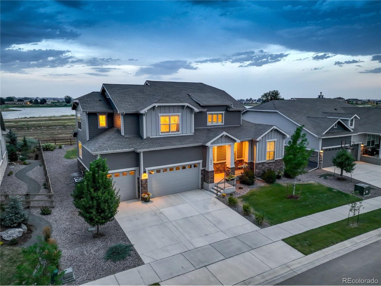 Two-Story Stunner with Unbeatable Views  Who says you can't have a water view in landlocked Colorado? This 4-bedroom, 3-bathroom, 4,763 square-foot masterpiece backs to open space and flaunts the best of both worlds: lake and mountain views! Balance the convenience of a short 10-minute drive to Old Town Fort Collins with the serenity of a beautifully designed and landscaped suburban neighborhood. Watch the wildlife, walk along the lakeside paths, and admire your front-row seat to the unbeatable Rocky Mountains through the seasons. The brand new, partially-covered concrete patio in the backyard provides the perfect spot for taking in the fresh air. Inside, the plentiful windows in this two-story home let in natural light throughout the day, allowing you to enjoy both sunrises and sunsets from the comfort of your home. Need a break from the sun? The Hunter Douglas shutters throughout the house make for easily adjustable lighting and a polished feel. Many rooms feature custom light fixtures and the open floor plan accentuates the open, airy nature of your unbeatable location. Designer finishes throughout the home include quartz countertops, LVP flooring, 8 foot tall doors, multiple walk-in closets, and much more. With the primary suite on the main level, this home prioritizes comfort and convenience. The suite includes a large walk-in closet, a beautiful 5-piece primary bathroom with stunning tile and granite, and custom blackout double drapery blocks out the early light for the best possible rest. From views and location to upgrades and designer finishes, this home has it all. Don't miss your chance to see it!