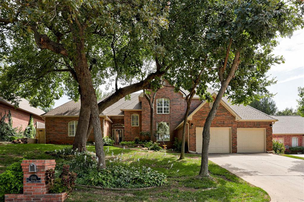 Stately one owner Edmond home perched on a heavily wooded lot in The Oaks. When you step inside you are greeted with a beautiful living area with 3 floor to ceiling picture windows ushering in amazing natural light. This living area connects directly into the kitchen and a breakfast nook dining area. A second lovely living area with a beamed cathedral ceiling, fireplace, built-in book shelves and another bank of picture windows sits on the other side of the kitchen/breakfast nook. The perfectly appointed kitchen has been recently updated with a stunning quartz countertop, new double ovens, microwave and dishwasher. For your more formal gatherings there is a spacious second dining area off the kitchen. Both dining areas have new on-trend light fixtures. This flexible floorplan offers the best of all worlds with a "great room" as well as more defined spaces. The Primary bedroom suite has a private living area with fireplace and built-ins for the perfect reading room, office or home gym. Both the bedroom and living area have new ceiling fans. The Primary ensuite bathroom offers two vanity areas, seperate tub and shower and a huge Australian closet. There is a second bedroom suite downstairs as well as two bedrooms with a Jack & Jill bathroom upstairs. TRUE 4 bedroom home! The backyard is a serene wooded retreat with beautiful landscaping. New roof in 2024. Freshly painted exterior. Versalift and storm shelter in garage.