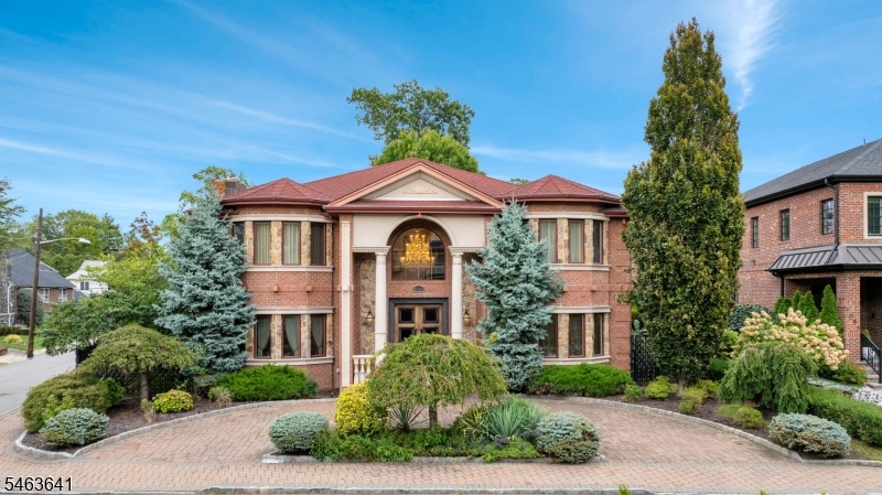 European artistry. Exceptional craftsmanship. Set on a corner property in Fort Lee, this custom built 2010 Colonial offers 4 spacious BRs, 4.5 baths & extraordinary imported finishes. Heated foyer floors, Italian silver plated doors, European flooring & moldings, Italian lighting & chandeliers set an elegant tone. Four fireplaces include a great room showpiece with imported Italian columns & marble. Custom wallpaper, intricate tilework, tailored baseboard covers & custom spotlights enrich the interior, reflecting a level of detail that makes this home exceptional. A custom office features Italian furnishings. The kitchen boasts custom cabinetry, Miele cooktop, dishwasher & coffee machine, Viking hood & Sub-Zero fridge & wine fridge. Upstairs, the expansive primary suite offers a fireplace, private balcony, oversized walk-in closet & ensuite bath with Swarovski crystal tile. All second-floor baths have heated floors, while a 2nd floor laundry room w/ Miele washer & dryer adds convenience. The finished basement features a sauna, wine cellar with secure access, additional living space & potential guest bedroom. Crestron smart home technology, concealed speakers, Hi-View cameras, alarm system & generator deliver comfort & peace of mind. Custom wrought iron fencing imported from Spain, exterior spotlights, pillar lighting & epoxy garage floors complete the property. Convenient to the GW Bridge, NYC & transportation, this remarkable home unites European elegance with modern luxury.