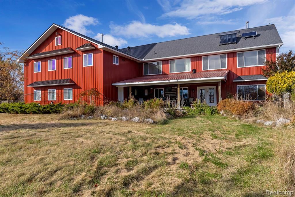 Welcome to this stunning energy efficient Barndominium Retreat, located in Tawas City!  This amazing 6 bed, 4 bath property is a perfect blend of rustic charm and modern luxury.  With three well-appointed kitchens, this home is designed for entertaining and family gatherings, featuring spacious serving areas that make hosting a delight.  The open-concept living spaces are bathed in natural light, showcasing beautiful rooms that add to the warm, inviting atmosphere. Each of the six bedrooms offers ample space and comfort, ensuring guests and family alike feel right at home.  The home is heated through tubing in the floor by hot water heat, which could be propane fed or solar powered.  Should solar energy be used, you can get a credit from Consumers Energy!  There are also cooling tubes run underground that come into the home in the winter, so you're only heating from 50 degrees starting temp.  On this property you will find a 2-story chicken coop, windmill (not currently operating), gazebo with wood stove, powered shed for sheep, pig pen with fencing, orchard with water and electricity ran to it, fenced-in dog kennel with entrance into a section of the garage, fire wood storage and large greenhouse.  In the basement you will find both a wet and dry cellar.  The property attracts an abundance of wildlife with both a creek and ravine running through the property.  This is not only a home, but a lifestyle, offering a unique blend of tranquility and versatility.
