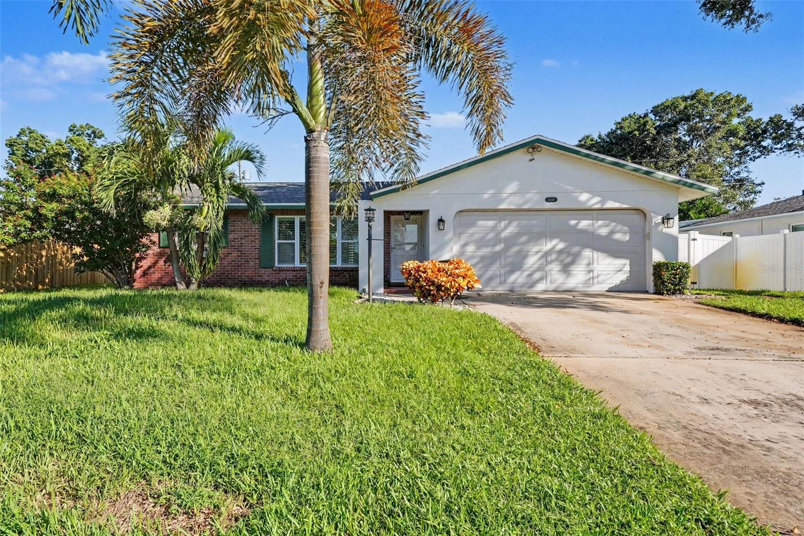 Virtually Staged. Short Sale. RARE PINELLAS POOL HOME WITH NO HOA AND NON-FLOOD ZONE X. Welcome to your private coastal retreat perfectly situated in central Largo. Offering the ultimate Florida lifestyle with total financial peace of mind, this 3-bedroom, 2-bathroom, 1,424-square-foot block home requires NO FLOOD INSURANCE and has ZERO HOA restrictions. Inside, you will find a bright, open, and highly functional split-bedroom layout designed for comfortable everyday living. The main living areas feature easy-to-maintain tile flooring, elegant crown molding, and custom plantation shutters that allow abundant natural light to fill the space. The well-equipped kitchen provides solid wood cabinetry, a crisp white tile backsplash, and a complete suite of stainless steel appliances. The primary suite acts as a true retreat, offering warm wood-look floors and ample space to unwind. The focal point of this property is the expansive outdoor living area. Step through the sliding glass doors into a massive, shaded screened lanai that flows seamlessly into an oversized, fully fenced backyard. The centerpiece is a pristine IN-GROUND PRIVATE POOL surrounded by a spacious sun deck and accented by a custom coastal surfboard mural. Located to maximize everyday convenience, you are just around the corner from the Southwest Recreation Complex's Olympic-size swimming pool and lighted tennis courts, and under 10 minutes from the soft sands of the Gulf Beaches. Schedule your private tour today!