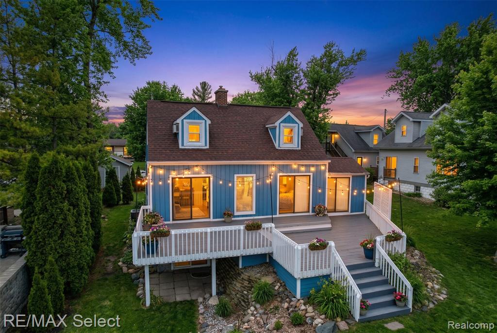 Experience the best of lakefront living on sought-after all-sports Lake Fenton with this spacious and beautifully updated Cape Cod offering 40 feet of private frontage. With over 2,600 square feet of living space, this 3-bedroom, 2-bath waterfront retreat seamlessly blends timeless character with modern updates in a setting that feels like a year-round getaway.The main level showcases new luxury vinyl plank flooring and fresh paint (2021), creating a bright, inviting atmosphere throughout. Expansive windows and multiple skylights flood the home with natural light, highlighting the thoughtfully updated kitchen featuring stainless steel appliances and solid surface countertops. The firelit living room offers tranquil lake views and direct access to the deck—perfect for entertaining or simply unwinding by the water.Upstairs, a finished bonus room above the garage provides flexible space ideal for a home office, guest suite, or creative studio. The partially finished walkout lower level, complete with a second fireplace, offers additional living space and potential for a fourth bedroom or recreation area.Notable updates include a renovated main floor bath (2022), new well tank (2022), new garage doors (2023), electrical & surge protector (2023) and new water heater (2024) ensuring peace of mind and added value.Step outside to enjoy your private lakeside setting, complete with a spacious deck, fire pit, and sandy beach—perfect for hosting, relaxing, or enjoying all that Lake Fenton has to offer, from boating and swimming to peaceful sunset views.This is a rare opportunity to own a move-in ready waterfront home combining space, style, and direct access to one of the area’s premier all-sports lakes.