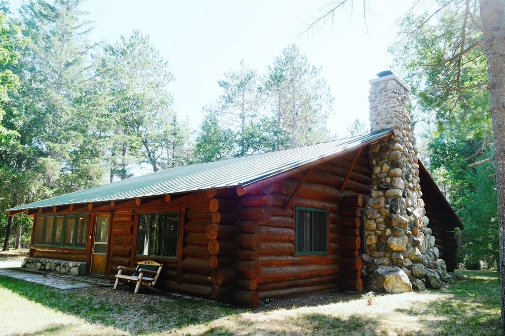 FULL LOG! This rare, historical log cabin in northern Michigan offers timeless charm, tucked in the peaceful, wooded acreage with winding trails and abundant wildlife. Perfect for hunting and outdoor recreation and a true fly fishermans paradise! Its just a short walk to the world-renowned S. Branch of the AuSable River-Mason Tract, celebrated for its unmatched trout fishing, canoeing, tubing and kayaking. The historical 3 bedroom 1.5 bath lodge proudly marks its 100 year anniversary THIS YEAR, and originally built by the famous author James Oliver Curwood. It showcases a one of a kind 300-ton stone chimney and gorgeous fireplace, the cabin is as striking as it is unique. Even Curwood himself once proclaimed, ‚Å“I wouldnt trade that cabin for all of Europe.‚  This is more than a property-its a once-in-a-lifetime opportunity to own a piece of history in Michigans great outdoors. Theres more! A 24x38 full log garage, hunting plot, blinds, a giant enclosed screen porch, covered front porch, vaulted ceilings, wood floors and even borders State Land with the river to the North and Federal Forest to the South! The log exterior and stonework were extensively renovated, along with steel roofs in 2023 so not much to do but enjoy! Close to trails and great golfing too!