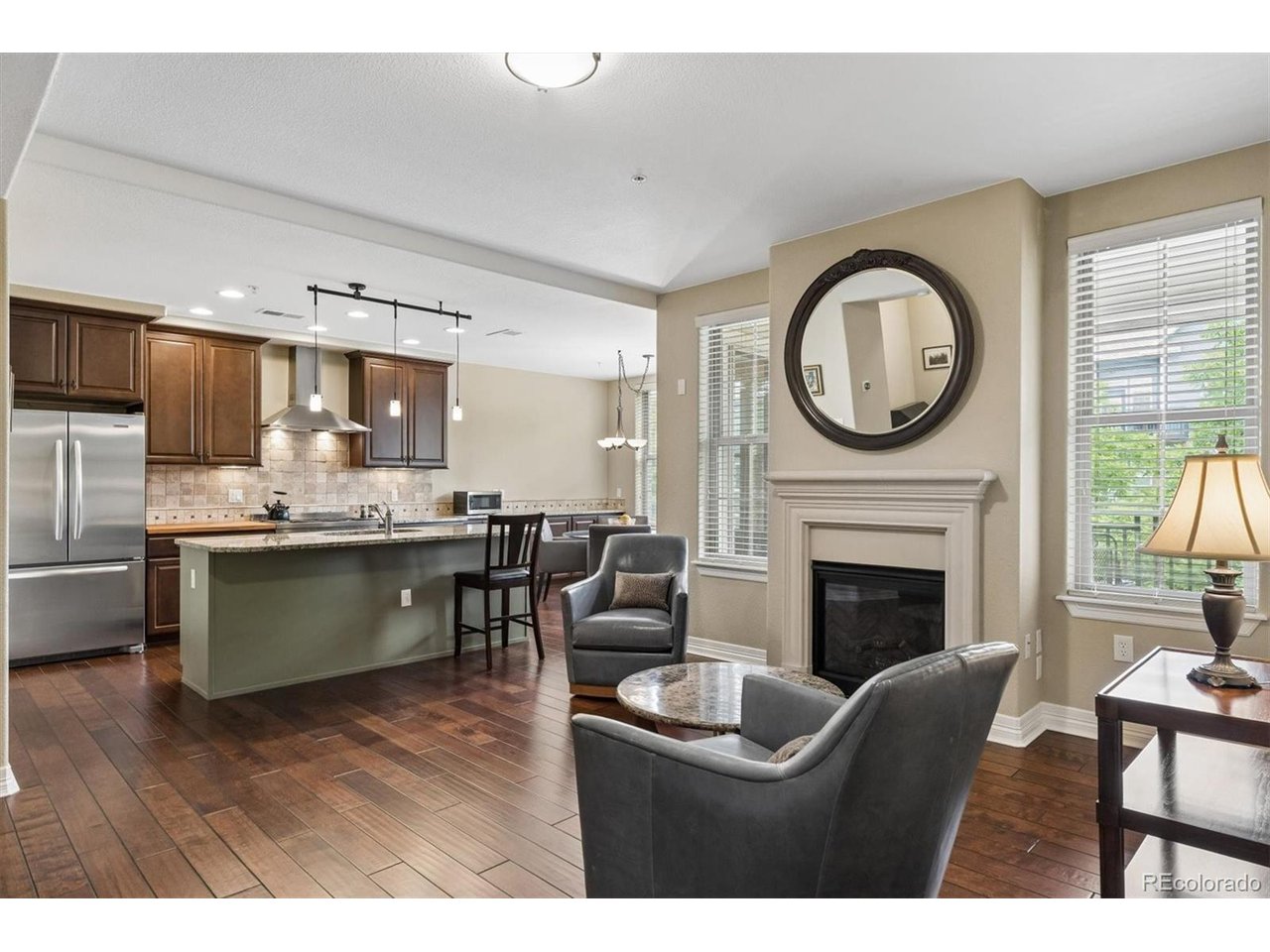 Rare opportunity to purchase an end-unit luxury boutique condo just one block from the hugely popular Historic Old Littleton Main Street! This stunning residence offers the perfect lock-and-leave lifestyle with upscale finishes, thoughtful design, and unbeatable walkability. Elevator access from all levels including parking garage. The unique 2-story primary suite features a massive walk-in closet complete with in-unit washer and dryer, creating the ultimate private retreat. Building was designed to have no one living above this condo despite being a mid-level unit. The bright and open main living area boasts 9-foot ceilings, solid wood doors, engineered wood floors, and a dedicated office space ideal for working from home. The gourmet kitchen is beautifully appointed with granite countertops, 42" cabinetry, stainless steel appliances, gas range, pantry, and more! Enjoy seamless indoor-outdoor living with a private balcony accessible from both the kitchen and primary bedroom. Designated secured underground parking that also includes the largest private storage unit in the building. You can't beat this location being just blocks away from popular restaurants like Smokin' Fins, ViewHouse, Melting Pot, along with being near numerous independent boutiques and galleries!