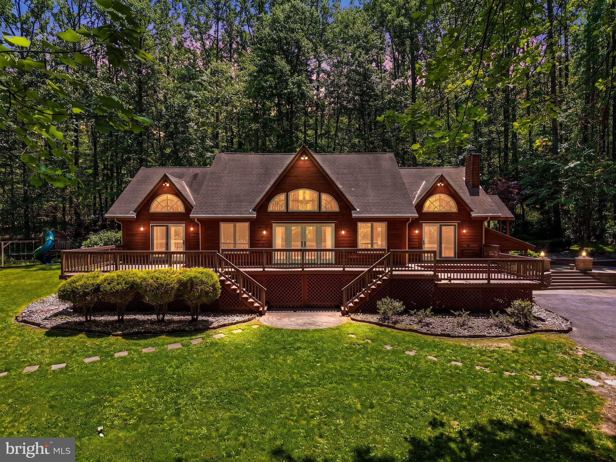 Welcome to 59 Hopewell Rd, a truly one-of-a-kind retreat nestled on more than 16 private acres in the rolling countryside of Elverson. Offering a rare combination of natural beauty, recreation, and tranquility, this exceptional log home is perfectly positioned alongside French Creek and backs to over 200 acres of State Game Lands, creating an unmatched setting for outdoor enthusiasts, equestrians, entertainers, and anyone seeking a peaceful escape from the everyday. From the moment you arrive, you'll be captivated by the property's picturesque landscape, mature trees, open green spaces, stocked ponds, and the sense of privacy that surrounds you. Inside, the home showcases timeless log cabin craftsmanship with soaring ceilings, exposed beams, rich wood finishes, abundant natural light, and stunning stone fireplaces that serve as the focal point of the living spaces. Every room has been thoughtfully designed to embrace the surrounding views while creating a warm, inviting atmosphere that seamlessly blends indoor and outdoor living. The expansive outdoor spaces are where this property truly shines. Multiple decks and gathering areas provide the perfect backdrop for morning coffee, outdoor dining, sunset views, and entertaining guests. Spend your days fishing in the stocked ponds, exploring the property's acreage, enjoying nearby French Creek, or simply relaxing and taking in the sounds of nature. A horse barn offers opportunities for equestrian enthusiasts, hobby farmers, or additional storage and recreational uses. Adding to the property's versatility is a separate log carriage house, ideal for use as a guest retreat, home office, artist studio, fitness space, short-term rental opportunity, or private getaway. Whether you're hosting family and friends, creating a multigenerational living arrangement, or seeking a dedicated work-from-home environment, this additional structure offers endless possibilities. This remarkable property is more than just a home—it's a lifestyle. Imagine evenings gathered around a fire, live music drifting across the deck, weekends spent fishing and exploring, and holidays filled with family and friends making memories that last a lifetime. Rarely does a property offer such a unique blend of privacy, recreation, flexibility, and natural beauty, all within a convenient location. If you've been searching for a place where adventure, relaxation, and timeless charm come together, 59 Hopewell Rd is the retreat you've been waiting for. A truly extraordinary opportunity to own your own private slice of Berks County paradise.