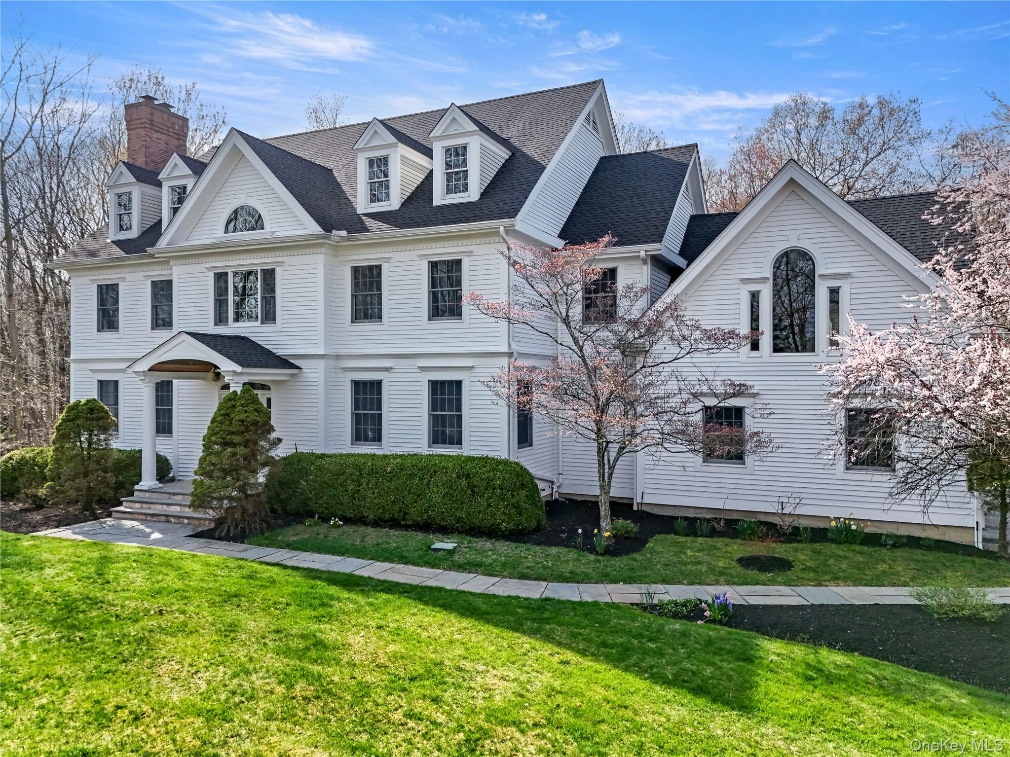 Welcome to 10 Samuel Dann Way, a refreshed, classic center hall Colonial set on a peaceful cul-de-sac in a sought after neighborhood. The large living areas filled with natural light flow effortlessly, offering the perfect backdrop for entertaining or relaxing at home. The kitchen is complete with sleek countertops, double ovens, two dishwashers, ample cabinetry and is open to the informal living area with soaring fireplace. There are multiple work from home areas, including separate offices on the first and second floors.The primary suite is a personal retreat, featuring generous closet space, new carpeting and a spa-like en-suite bathroom. Additional bedrooms are well-sized and versatile. There is also a separately accessed guest suite with bedroom, bonus room and full bathroom. The walk out lower level provides recreational areas and plentiful storage.The elevated residence with lovely land is a true sanctuary with sprawling lawn and space for a pool. Most appealing, the property is privately set and surrounded by woodlands.Located just moments to charming Scott's Corners and to New Canaan, with shops, parks and restaurants, 10 Samuel Dann Way offers the perfect blend of convenience and tranquility.