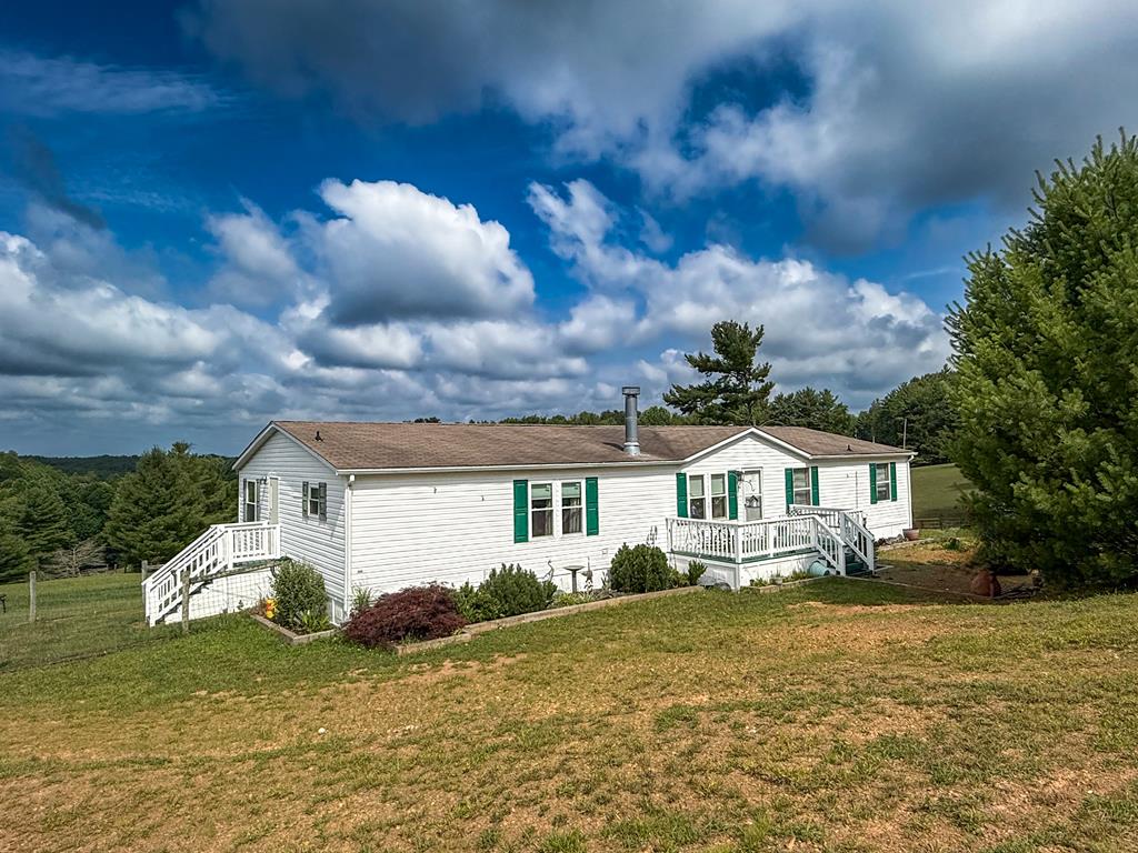 Welcome home to this spacious 5-bedroom, 3-bathroom doublewide on 2 peaceful acres. From the moment you step inside, you'll appreciate the open living room and dining area that create a warm, welcoming space for gathering with family and friends. On cooler evenings, curl up by the cozy fireplace and enjoy everything the home has to offer. The oversized kitchen is truly the heart of the home, featuring abundant cabinet and counter space along with a charming breakfast nook that's perfect for slow mornings, family breakfasts, or catching up over coffee. With five comfortable bedrooms and three full bathrooms, there's room for everyone to spread out while still feeling connected. Step outside to enjoy the cleared yard, offering endless opportunities for gardening, outdoor games, entertaining, or simply relaxing and taking in the fresh country air. Whether you're looking for more space, a place to grow, or a peaceful setting to call home, this property is ready to welcome its next chapter.