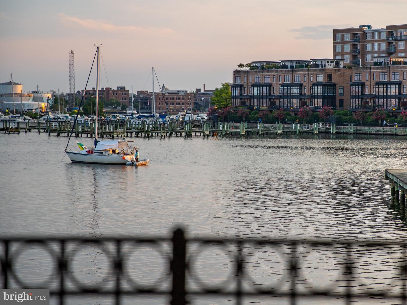Live authentically. If you’re looking for one-of-a-kind waterfront, this is it. The only fully custom home in desirable North Shore. Purchased directly from the developer during framing and fully reimagined with a totally unique floor plan and top of the line materials. Step inside and instantly fall in love. Stunning custom walnut staircase greets you as you enter. A few more steps and your eyes will be wowed by the expansive views of sparkling water. Spacious ground-level en-suite bedroom with custom built-ins is flanked with a wall of glass that stretches the entire width of house and walks directly out to the promenade. Step upstairs to a sophisticated space anchored with intentional design. This main level offers a unique layout with the perfect blend of defined spaces and seamless flow. Designed to live like a true home, this middle floor offers two living and dining spaces, both formal and casual, two fireplaces, a powder room and three walls of glass. The glistening 7” wide walnut plank floors are unlike anything you’ve seen in North Shore and are the perfect compliment to the custom crisp white plantation shutters and window treatments throughout home. Gorgeous eat-in kitchen with top of the line appliances and an elevated casual dining nook with the very best view. Step up one more level to a peaceful third floor reminiscent of a boutique hotel. Two gorgeous en-suite bedrooms and spacious laundry room. The primary is flooded in natural light with a balcony overlooking an unmatched view of the water. As one of only 12 houses on the Baltimore waterfront with breathtaking open water views that will never be developed, you can rest assured that what you see is what you get, forever. This home is incredibly maintained from top to bottom with all new Marvin Ultimate sliders and windows recently installed on the water side of property. Cultivate your existence. The art of uniting human and home.