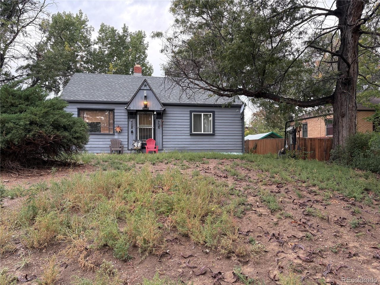 Incredible potential awaits on a rare lot in Wheat Ridge! Built with durable solid cement construction, this unique home offers flexible space that can easily be reconfigured into 4 or 5 bedrooms across the main level, attic, and basement. Key updates include a 9-year-old roof backed by a 35-year warranty, along with functional plumbing and electrical systems. Equipped with a swamp cooler for cooling, this property provides the perfect blank canvas to remodel the kitchen and baths to your exact taste. A fantastic opportunity to build massive equity on prime land. Property sold AS-IS