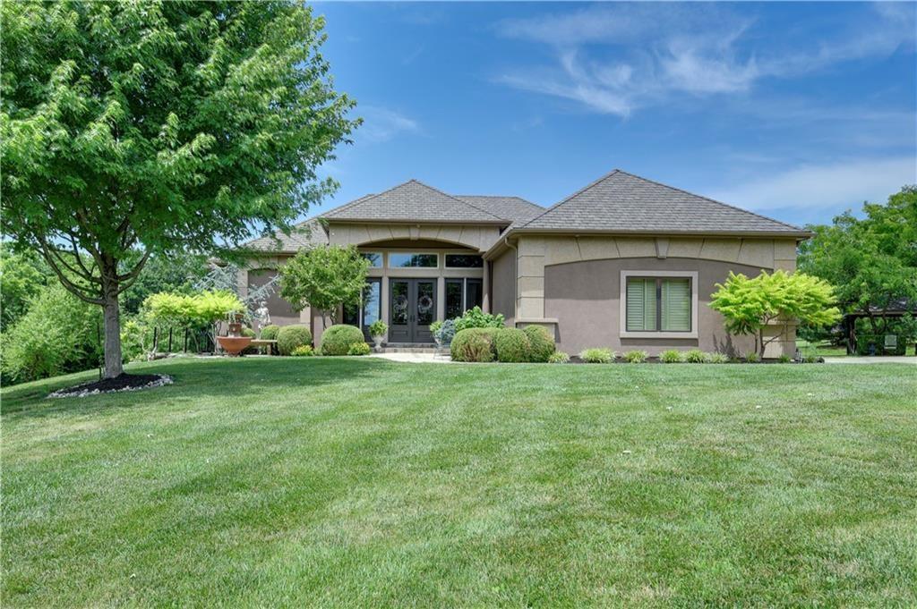 The most amazing 3 Acres with Reverse 1.5 Story home. 6 car garage (3 attached, 3 detached) 4,000SF home. Primary Bedroom on main with heated floors in the Master Bathroom, hearth room with fireplace, formal dining room, living room, large walk-in pantry powder room, eat in kitchen, Darling Porch. Finished Walkout Lower Level offers full kitchen, 3 additional bedrooms, storage, Bar area, Rec Room, and two full bathrooms. Hardy Board Siding, Hardwoods thru out most main floor, 3 outside sitting areas. Long Private Drive. Don't wait! You'll love it!