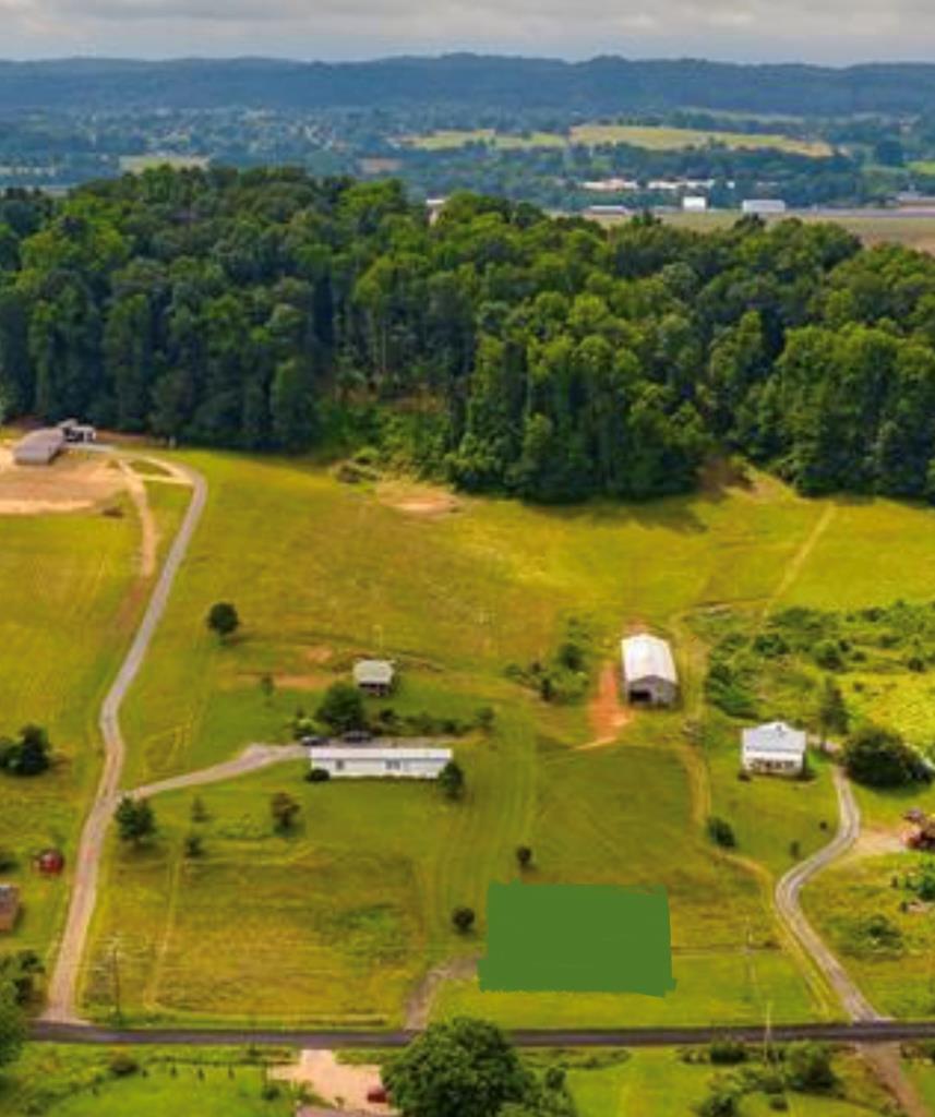 This is a great investment opportunity.  One singlewide mobile home,  and an out building that looks like an adorable cabin, and a barn, and plenty of extra acreage to build your dream home on. Call today for your showing!!