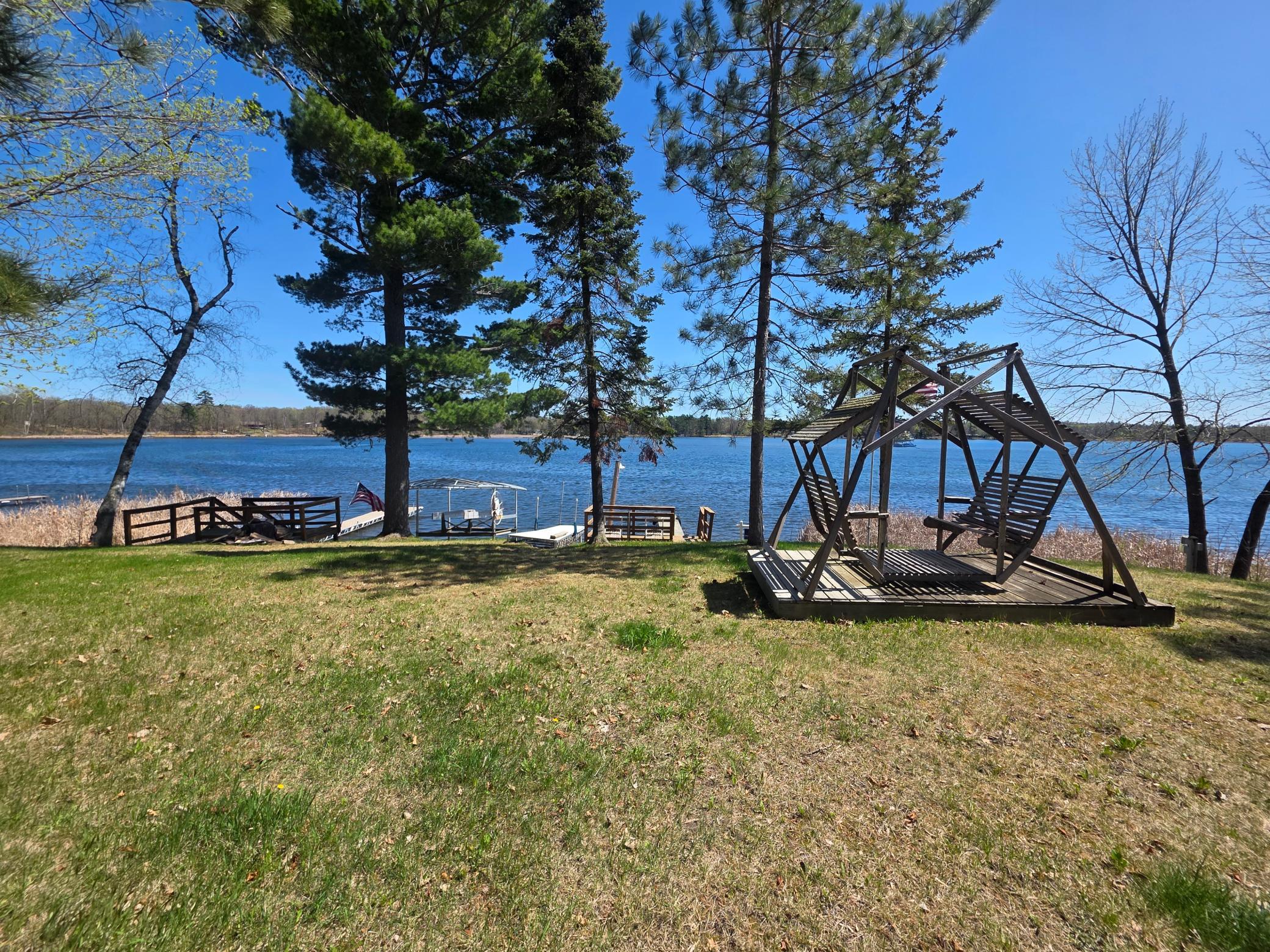 Charming lakeshore home on beautiful Woman Lake. Year round living, excellent fishing. Escape to the lake with this cozy 2-bedroom, 2 bath year-round home offering breathtaking views and serene surroundings. Nestled on 151+ feet of lakeshore on Woman Lake, one of the area's most sought after lake. Panoramic lake views from porch, kitchen, bedrooms. Oversized garage provides ample room for vehicles or toys. Whether you're looking for peaceful getaway or full-time lake residence, this is the home for you. 2 docks, pontoon lift, and small fishing boat included.