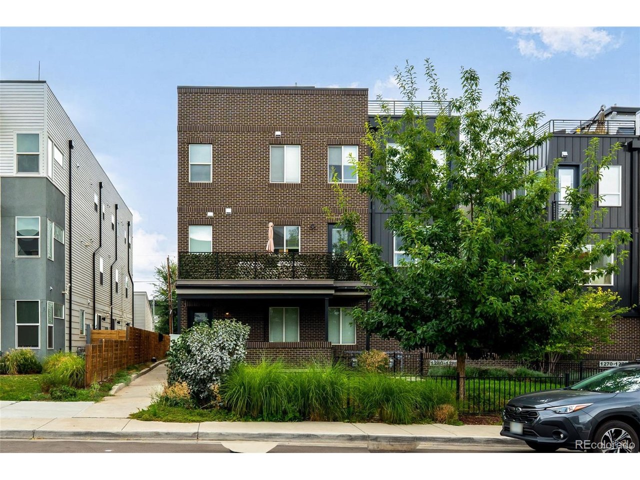 Don't miss this beautiful turnkey townhome, just steps from Sloan's Lake in one of the city's most sought-after locations, with an open concept floor plan designed for effortless everyday living. The main floor is home to the living room, dining room and kitchen, a perfect setup for hosting, with wide plank flooring, tall ceilings and plenty of natural light throughout. The kitchen is a chef's dream with pristine white and oak cabinetry, quartz countertops, tile backsplash, stainless steel appliances, a gas range and a pantry for extra storage. A large peninsula offers additional prep space and casual seating for morning coffee and meals. High end lighting throughout the main floor creates a luxurious space. Upstairs, the primary bedroom is spacious and bright, offering an oversized closet, a large en-suite bathroom with dual vanities and a walk-in shower, and additional space perfect for a cozy work from home area or reading nook. The rooftop deck is an incredible setting for morning coffee, afternoon hang-outs, or an evening under the stars, featuring spectacular city and mountain views. An attached garage with room for additional storage rounds out the practical perks. As an added bonus, there's no HOA. Your new home is just moments from Sloan's Lake, Lakewood Gulch Park, Edgewater Beer Garden, Edgewater Public Market, Alamo Drafthouse, and an abundance of coffee shops, retail, breweries, restaurants and entertainment. Perry Light Rail Station is a short walk away, perfect for commuting downtown, with quick access to I-25 and I-70 for those days you need to head out of the city. Welcome home!