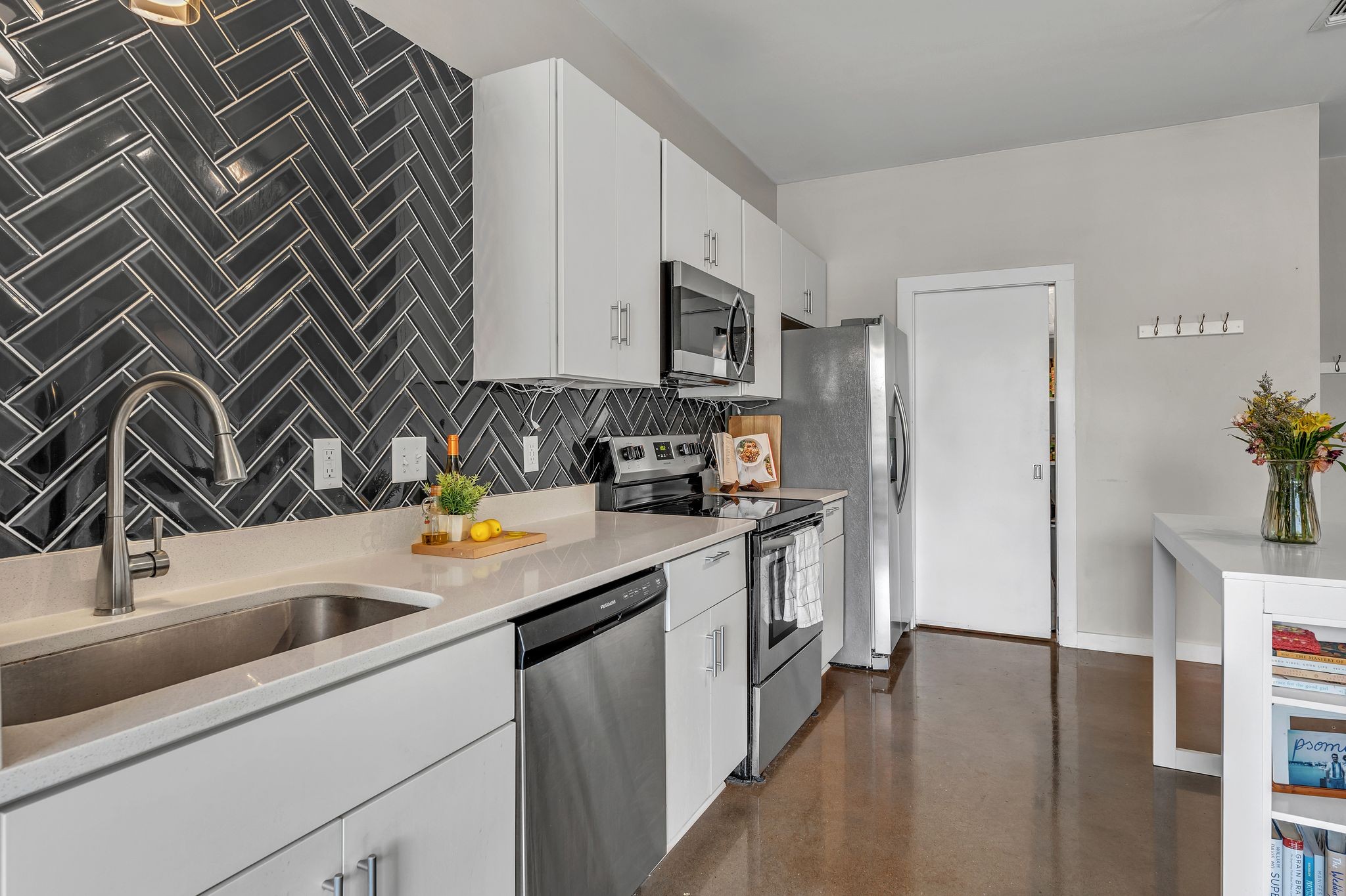 Price Decrease!! Turnkey condo just blocks from everything 12 South has to offer—Sevier Park, Music Row, Belmont, and Vanderbilt! Enjoy protected bike lanes now connecting 12 South to the Gulch! A true urban lifestyle right in the heart of Nashville with walkability to shops and restaurants! This premium 2-bedroom unit boasts the largest floor plan in the building, each bedroom with its own private bath and walk-in closet—ideal for roommates or guests.  Step out onto your expansive private balcony with stunning views of Belmont University and the new Belmont Medical School. Stylish upgrades include custom navy kitchen tile, quartz countertops, stainless steel appliances, and designer lighting. Bonus features: Nest thermostat (NEW!), NEW refrigerator, New paint throughout, Washer & Dryer remain!  The Chelsea Condos offer top-notch amenities including secure garage parking, grilling and picnic area, welcome lobby, package room, sky lounge, sundeck, fitness center, recording/music room, bike storage, and a dog wash station. Current Rental permit transfers to new owner—a rare find in this sought-after building! (Waitlist for rental permits). Home is no longer staged.
