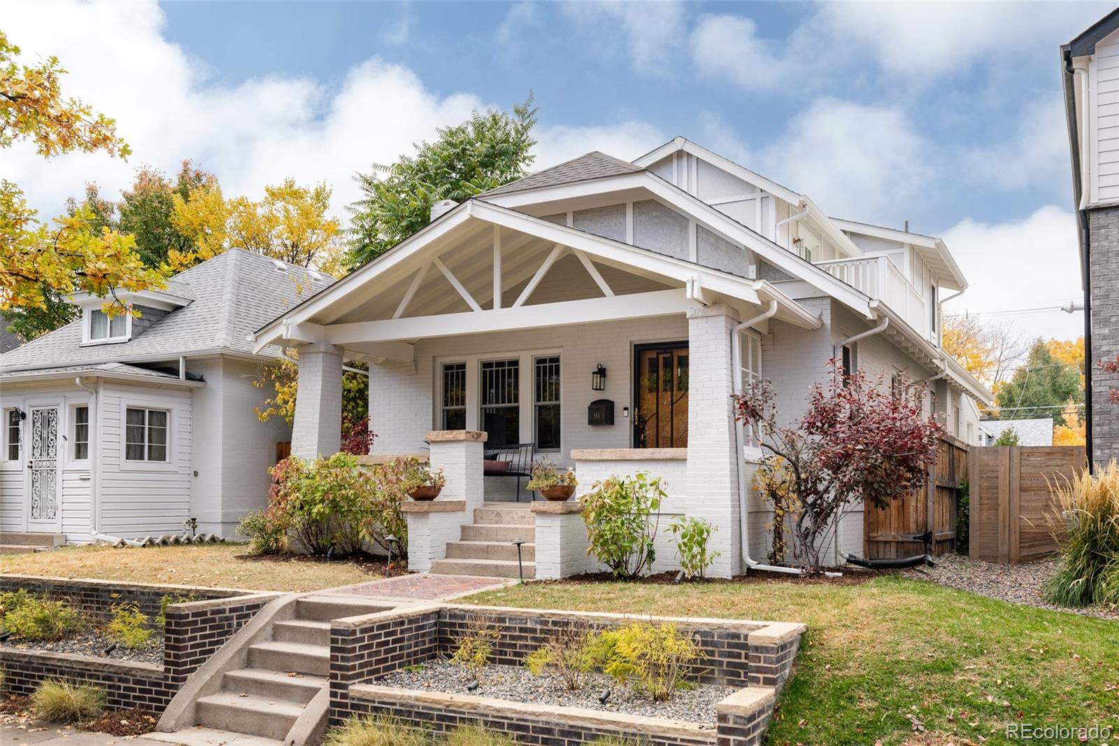 Timeless character meets modern sophistication in this beautifully updated raised bungalow in East Wash Park. Thoughtfully reimagined, this home perfectly balances original 1920s charm with contemporary comfort and design. From the moment you enter, you’re greeted by the warmth of the original fireplace with a handcrafted wood mantel, built-in cabinetry, and refinished hardwood floors. The formal dining room retains its character with stunning original built-ins, offering an inviting space for gatherings. The renovated kitchen is a chef’s dream, featuring new quartz countertops, a custom tile backsplash, and stainless steel appliances. Just beyond, a cozy family room offers the ideal spot for morning coffee, casual lounging, or a comfortable play space. The main level includes two inviting bedrooms—one with an adjoining flex space perfect for a home office or art studio—along with an updated full bathroom. Upstairs, the private primary retreat encompasses the entire second level. This serene space includes a sitting area, second laundry, and a spacious walk-in closet. The newly remodeled five-piece primary bath feels like a spa, with a curbless shower, heated tile floors, and a luxurious soaking tub. Step onto the private balcony and enjoy peaceful moments surrounded by tree-lined views. The full basement offers a generous living area ideal for movie nights or game-day gatherings, plus a stylish guest bedroom and full bath for visitors to enjoy in comfort and privacy. Outside, the backyard is designed for effortless entertaining with an outdoor gas fireplace, and room to relax or dine al fresco. A two-car garage provides excellent storage for vehicles and gear. Located just blocks from Denver’s beloved Washington Park, this home offers easy access to Cherry Creek, I-25, and the city’s best dining and shopping. A rare blend of historic charm, modern updates, and unbeatable location—this East Wash Park residence is Denver living at its finest. Welcome home.