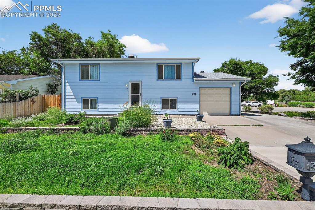 Welcome to this bright and functional bi-level home on a spacious corner lot! Enjoy new laminate flooring throughout the main level and brand-new carpet in the fully finished basement. The kitchen features a double pantry and plenty of cabinet space, while multiple hallway closets provide additional storage. The lower level offers a huge bedroom with an attached full bathroom, ideal for a private suite or guest retreat. Additional highlights include an insulated garage, central A/C, 220V in the backyard for a hot tub or workshop, and a chicken coop for urban homesteading. The fully fenced backyard includes a 13x10 elevated deck, while the front yard boasts a culinary herb garden. Great curb appeal, smart layout, and truly move-in ready!