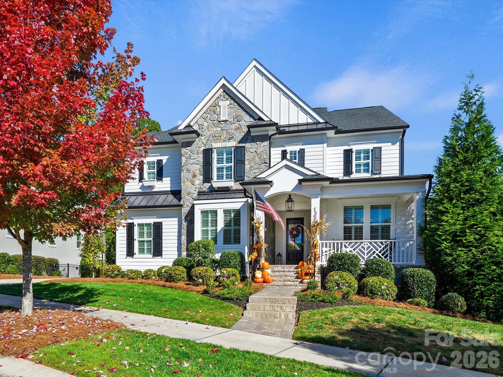 Some homes are beautiful. Others make you feel at home the moment you arrive. This one is both! Exceptional craftsmanship, timeless Southern architecture and thoughtfully designed living spaces distinguish this stunning Classica Homes residence. A welcoming front porch introduces an interior filled with architectural details, including elegant millwork, coffered ceilings and a striking great room fireplace. The gourmet kitchen is truly the heart of the home, featuring an expansive island, white cabinetry, statement range hood, gas range with pot filler and an exceptional butler's pantry with custom cabinetry and generous preparation space. Designed for both everyday enjoyment and memorable entertaining, the open floor plan flows beautifully into the dining and gathering areas. Step outside to the covered rear porch, where a magnificent stone fireplace and wooded backdrop create an inviting outdoor retreat. Upstairs, the luxurious primary suite features a spa-inspired bath and spacious closets, while additional bedrooms and a versatile loft offer flexibility. The finished basement provides even more possibilities with a bedroom, full bath and expansive recreation area. A dedicated main-level office overlooking the front porch adds convenience and charm. Located just minutes from Birkdale Village and downtown Huntersville, with a beautiful greenway across the street. Extraordinary craftsmanship, exceptional living spaces and a setting to enjoy in every season. This is a home that deserves to be experienced!