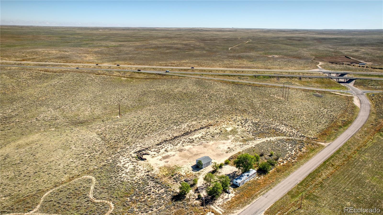 Almost 3 Acres Near I-76 in Hillrose! ~ Rare Opportunity in Washington County! This Acreage Property Comes Equipped with Propane, Electricity, Well Water, and Septic. ~ Features include a 576 sq. ft. 2-car Garage with Concrete Floor, and a Mobile Home included but not Part of the Sales Price Due to Condition. ~ Flexible Use—ideal for a Residence (modular or stick-built) or Possible Commercial Potential such as a Gas Station given its Prime Location Off I-76. ~ Just Minutes from Pruitt Reservoir, ~ Enjoy Easy Access to Fishing, outdoor recreation, and surrounding Communities. ~ Info from County and Buyer to Verify.