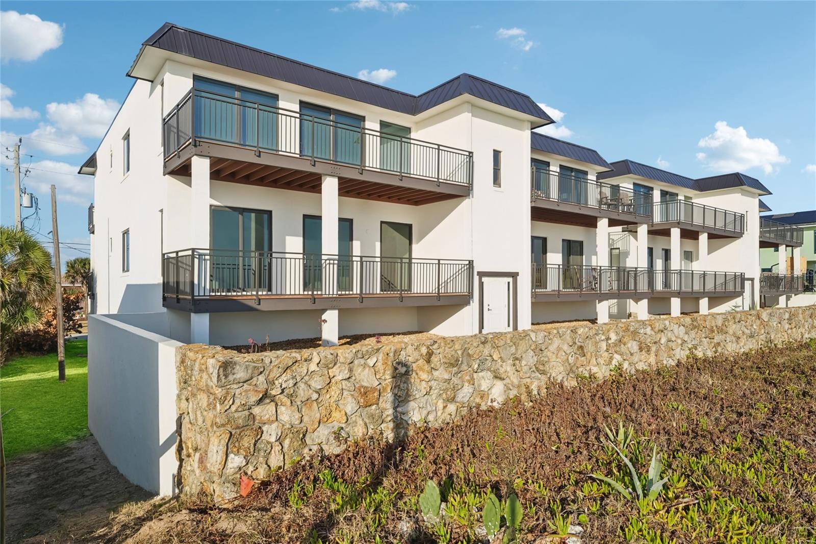 One or more photo(s) has been virtually staged. Wake up to breathtaking ocean views in this beautifully updated 2-bedroom, 2-bath condo located right on A1A in the heart of Flagler Beach! Start your morning with a stunning sunrise from your oceanfront balcony and unwind in the evening with tranquil intracoastal sunsets from your private bedroom retreat. This light-filled home features an open floor plan with floor-to ceiling windows, luxury vinyl plank flooring, and granite countertops throughout. The spacious primary suite offers a private en-suite bath, while the second bedroom includes direct access to the main bathroom. A generously sized laundry room with a utility sink adds extra convenience.Flagler Beach is known for its uncrowded beaches, friendly small-town atmosphere, and charming retro vibe. The area offers a variety ofattractions including historic state parks, a scenic fishing pier, and ample opportunities for outdoor activities such as surfing, kayaking, andfishing. Enjoy coastal living at its best—just steps from the beach, local restaurants, and a nearby boat launch. Seller is willing to cover up to six(6) months of the buyer’s Homeowners Association (HOA) dues with an acceptable offer.