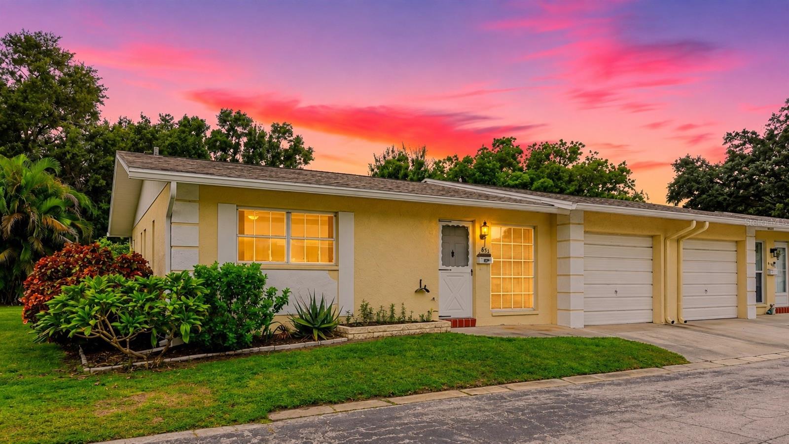 Virtually Staged. Check out your new place to call HOME in Heather Hill's adorable 55+ community! Ideally located just minutes from everything that makes Dunedin such a sought-after Florida destination, this charming END-UNIT villa offers the perfect blend of comfort, convenience, and low-maintenance living. There are VERY FEW units in Dunedin with a PRIVATE GARAGE! Located approximately one mile from vibrant Downtown Dunedin, you’ll be close to local restaurants, shops, scenic biking trails along the Pinellas Trail, beautiful coastal waters, and everything this charming community has to offer. Golf enthusiasts will also appreciate the abundance of private and public courses throughout the surrounding area as well as public pickleball courts nearby.As an end unit, this villa enjoys plenty of natural light and features a screened-in lanai overlooking a spacious, beautifully maintained lawn. Located within the Heather Hill Villas condominium association, the monthly association fee includes a HEATED POOL overlooking a serene LAKE, shuffleboard courts and a clubhouse with an activities/meeting room, a library sitting area, small kitchen and game room. There is also wifi and Cable TV for residents! Exterior maintenance and other community services and infrastructure are also included, helping make everyday living that much easier.Inside, you'll find several updates already completed, including two REMODLED bathrooms with zero entry showers, an updated living room, newer lanai windows, door and screens, UPDATED electrical receptacles, and an electrical panel replaced with permit approximately six years ago. The kitchen features laminate countertops, while the bathrooms offer granite countertops, with tile and carpet flooring throughout.With its desirable end-unit location, low-maintenance lifestyle, thoughtful updates, and plenty of opportunity to add your own personal touches, this villa is a wonderful place to enjoy all that Dunedin has to offer.