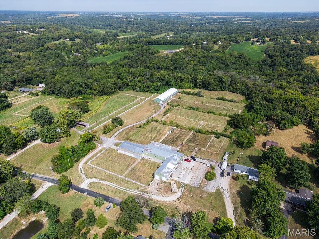 UNLIMITED POTENTIAL: WAREHOUSE, CONTRACTOR STORAGE, HORSES, ETC. Unique property, just up from River Road or Hwy 3-  featuring two insulated warehouse buildings totaling over 20,000 sq ft with reinforced concrete floors and a loading dock in each building. One building offers 9,616 +/- sq ft with a lower level including an additional 2855+/- sq ft, oversized auto garage door, man door access, and a drivable ramp to the basement. The second building provides 8,832 +/-sq ft, also with oversized garage doors. Both structures have separate electric service, some climate-controlled space, and are secured by extensive fencing and gated access. Gravel drives lead to a commercial tenant (month-to-month lease) on the right side and to the building at the rear of the property.The land includes wooded areas, fencing, and tiered lots where greenhouses once stood, complete with concrete walkways, steps, and a drivable ramp. Zoning is currently miscellaneous residential, previously agricultural with commercial use, offering tremendous potential for owner storage, future building, or possible regulated commercial use with county approval. FRONT BUILDING CURRENTLY OCCUPIED BY COMMERCIAL TENENT month to month.  NO TRESPASSING ON PROPERTY WITHOUT BEING ACCOMPANIED. Primary use is by owner for storage and recreation. Agent related to LLC owner. Being sold AS-IS. NO REPAIRS. SHOWINGS ONLY WHEN OWNER IS AVAILABLE TO MEET. CAMERAS ON PROPERTY.