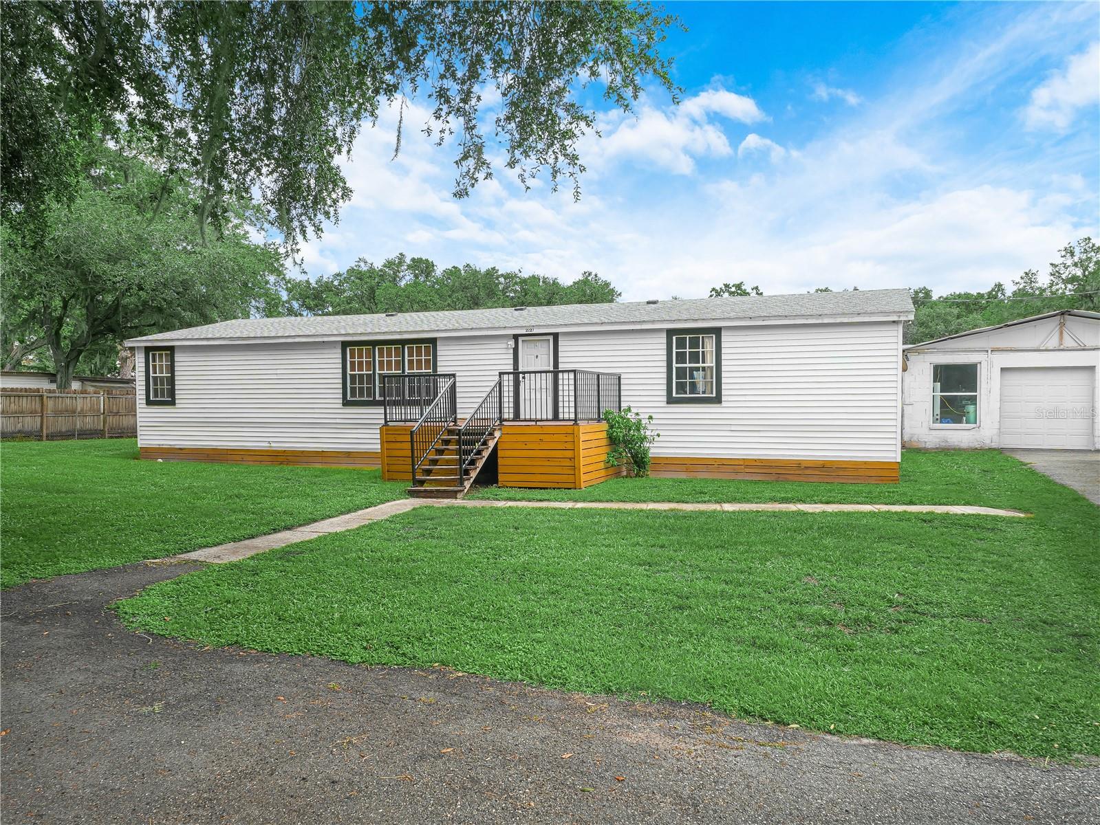 Charming 4-Bedroom Home on 1.25 Acres with Detached Garage in Plant City
Welcome to your private retreat just minutes from Highway 39 in Plant City! Nestled on a spacious 1.25-acre lot, this well-maintained 4-bedroom, 2-bathroom mobile home offers the perfect blend of comfort, functionality, and outdoor space.

Step inside to a large living room ideal for relaxing or entertaining. The separate formal dining room is perfect for hosting gatherings, while the kitchen features ample cabinet and counter space—a dream for any home chef. All appliances are included for your convenience.

Enjoy casual meals in the dinette area, where French doors open to a screened lanai, perfect for enjoying Florida’s beautiful weather. The split bedroom floor plan offers privacy, with a spacious main bedroom featuring a walk-in closet and en suite bathroom. Two additional bedrooms share a second full bath.

Outside, the 28' x 30' detached concrete block garage provides plenty of space for vehicles, storage, or a workshop. The fully fenced yard is ideal for pets, play, or even your own private garden.

Don’t miss this opportunity to own a slice of country living with city convenience!