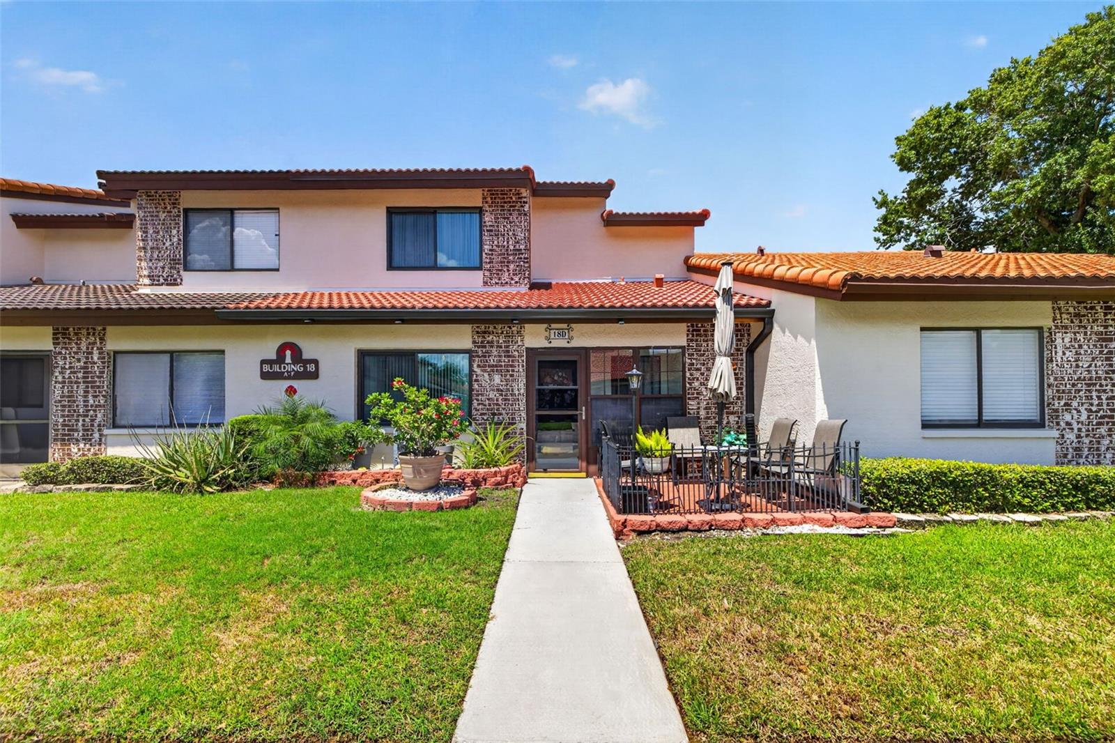 Virtually Staged. Discover comfortable, low-maintenance living in Rosetree Village, a beautifully maintained, pet-friendly community tucked away in a convenient central location. This inviting 3-bedroom, 2-bath townhome offers 1,375 square feet of a thoughtfully designed floor plan with tasteful updates and plenty of space for everyday living and entertaining. Step inside to find a warm and welcoming interior featuring a combination of tile, wood, and laminate flooring, elegant crown molding, newer interior doors, and updated bathrooms. The well-appointed kitchen features wood cabinetry, granite countertops, and stainless steel appliances, creating a functional space for preparing meals and gathering with family and friends. A first-floor bedroom provides added flexibility and convenience, while the additional bedrooms upstairs provides comfortable accommodations. Hurricane windows provide added peace of mind, and the interior laundry room makes everyday chores convenient. Enjoy even more living space with an enclosed front porch and an expansive enclosed rear porch, ideal for relaxing, entertaining, or creating a versatile bonus area. An additional storage room provides plenty of space for seasonal items and everyday necessities. Additional upgrades include 2 mini-splits - 1 in sunroom & primary bedroom, crown molding, decorative chairrail and a water softener system. Rosetree Village offers residents an array of amenities, including two community swimming pools, a playground, and basketball court, all surrounded by well-maintained grounds. Conveniently located just off Ulmerton Road, you'll enjoy easy access to shopping, restaurants, Tampa, St. Petersburg, major roadways, and Florida's top rated beautiful Gulf beaches.