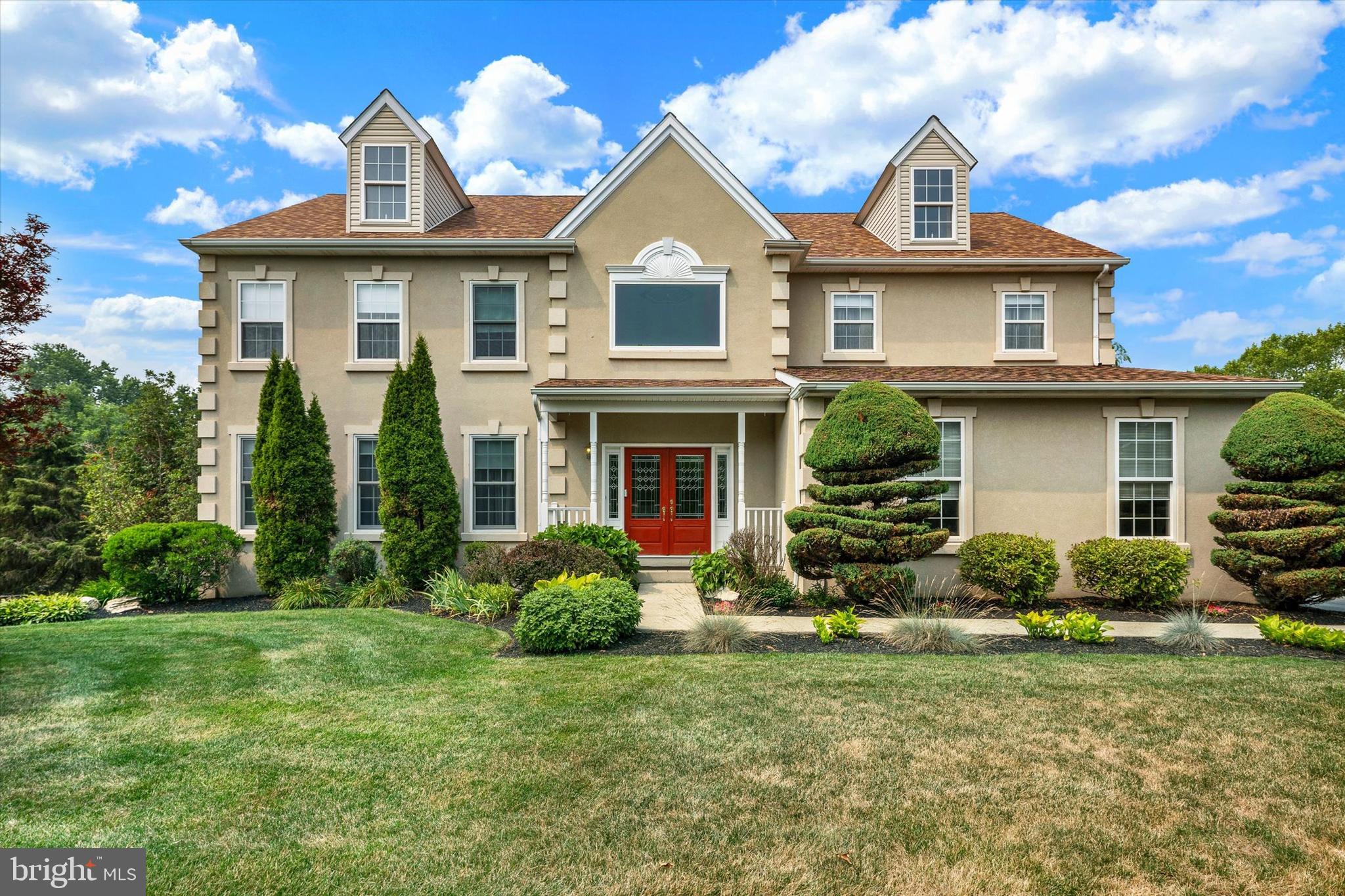 Welcome to this stunning 4-bedroom, 2.5-bath French Provincial-style colonial nestled in the sought-after Windgate Farms community and Owen J. Roberts School District. Set on a beautifully manicured, fenced lot with mature landscaping, this home makes an unforgettable first impression from the moment you arrive. Step through the front door into a dramatic two-story foyer, accented by a striking curved staircase, custom wainscoting and rich hardwood flooring. The formal living room offers custom built-in bookshelves, warm neutral tones, and abundant natural light, while the impressive formal dining offers an ideal space for hosting memorable gatherings. The heart of the home is the beautifully updated eat-in kitchen, featuring granite countertops, crisp white cabinetry, stainless steel appliances, a gas cooktop, and a spacious center island with seating. A sun-filled breakfast nook overlooks the private backyard, while an open flow into the family room makes everyday living effortless. The inviting family room family room is accented by gorgeous plantation shutters, cozy fireplace and walkout access to the back deck. A powder room is just around the corner and a sizeable convenient main-floor laundry with wet bar, complete this level. Upstairs, retreat to the generously sized primary suite, complete with a large sitting area, generous closet space, and an en-suite bath offering a corner soaking tub, glass-enclosed shower, and dual-sink vanity. Three additional bedrooms and full hall bathroom round out the upper level, all set beneath custom crown molding and warm, tasteful finishes throughout. Downstairs, the expansive basement offers incredible bonus space — a dedicated workshop with built-in pegboard storage for the hobbyist or DIYer, plus a spacious recreation area ready for a pool table, game nights, or additional storage. Completing this level is walkout access to the gorgeous backyard. Outside is where this home truly shines: a composite deck overlooking the grounds leads down to a private, fenced backyard oasis featuring an in-ground pool with a custom mosaic mermaid and tropical fish design, an attached spa, and a stone patio surround — perfect for entertaining or unwinding all summer long. Mature evergreens, sculpted topiaries, and flowering perennials complete this exceptional outdoor retreat. Conveniently close to major routes and shopping, this exceptional home offers the perfect blend of elegance, comfort, and resort-style outdoor living. Don't miss your opportunity to make it yours!