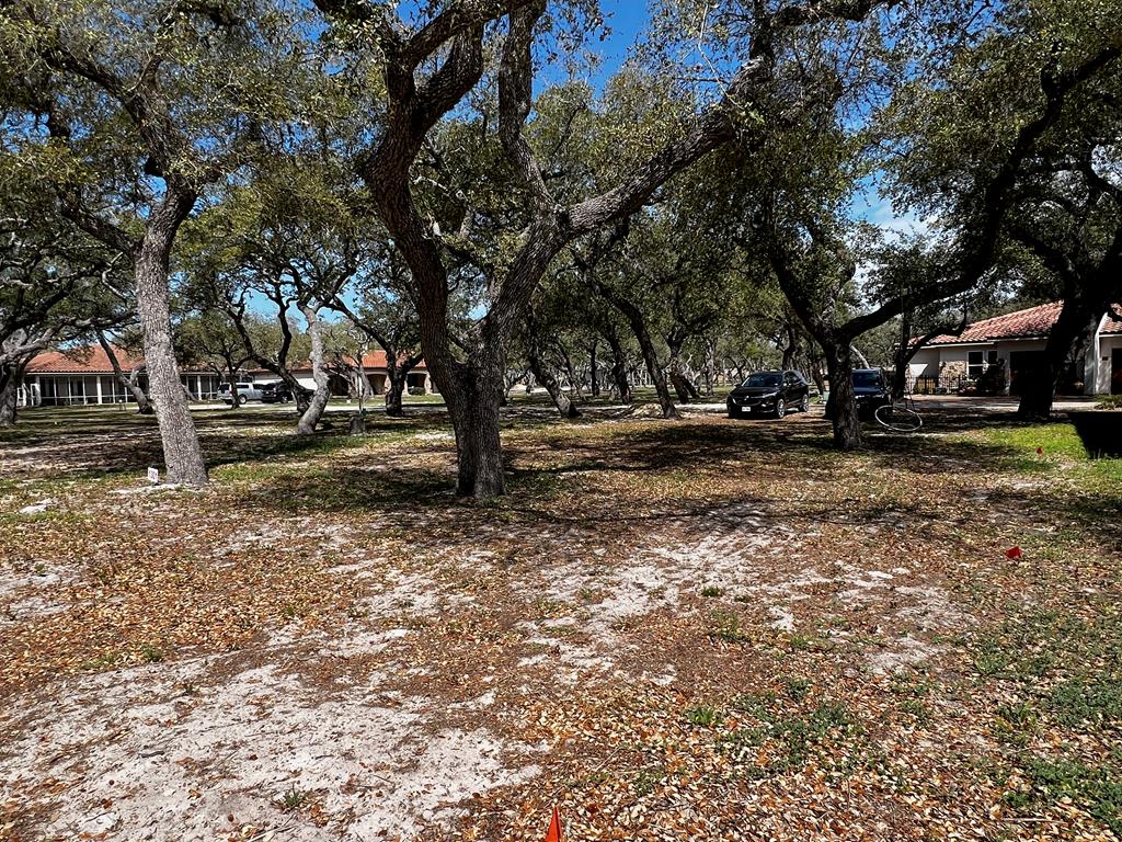 See what is behind the gate at Royal Oaks! The name says it all with majestic oak trees blanketing each lot. Only limited to one's imagination, this 4805 sq.ft. lot is ready for your custom build to commence. This exclusive gated waterfront community provides the pleasure of privacy with the storybook elegantly curved walls that line the front and back of the community. Entering the neighborhood over the cobble stone road from Fulton Beach Rd, past the guardhouse, immediately a rush of calm takes over. This therapeutic setting will be your place of peace and easy living. Take a minute to stroll the lighted walk paths to the gorgeous pool or gather under the gazebo. Invite friends for an evening around the fire pit to talk about the day on the boat while sipping on your favorite beverage. Need a little putting practice? Pick from the two greens overlooking the bay. Morning, afternoon or evening, the lighted fishing pier is the perfect place to drop a line.