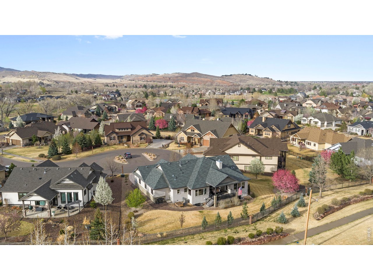 Welcome home to this exceptional 5-bedroom, 4-bath ranch-style home in the gated community of Overlook at Mariana, ideally situated on a quiet cul-de-sac where true Colorado living takes center stage. Inside, the thoughtfully designed open-concept layout features soaring ceilings, expansive windows, and abundant natural light that showcase sweeping Rocky Mountain views. The living room is anchored by a striking floor-to-ceiling fireplace, while oversized windows flood the space with light and frame the surrounding scenery. The spacious living area flows seamlessly into a well-appointed gourmet kitchen featuring granite countertops, a large pantry, and a convection range with gas connection behind should you choose to switch back. Ample counter space and a convenient breakfast bar make the space ideal for both everyday living and entertaining. A covered deck extends the living space outdoors, offering the perfect setting for relaxed morning coffee or alfresco dining while enjoying the wildlife that frequently visits the area. The landscaping has been thoughtfully designed with future privacy in mind, with strategic plantings that will mature into natural screening over time. An expansive 4-car garage provides exceptional space for vehicles, storage, and all your gear. Enjoy unmatched access to Mariana Butte Golf Course, nearby trails, and Boedecker Lake, offering year-round opportunities for recreation and relaxation. This is a prime opportunity to own in one of Loveland's premier gated communities, combining privacy, views, and the best of Foothills living.