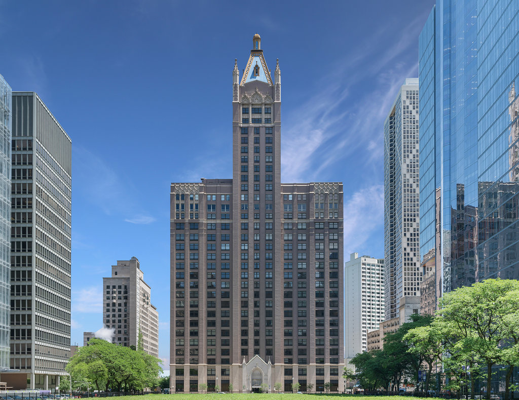 CONTEMPORARY ELEGANCE: This stunning 2,900 sq. ft. home, redesigned by the award-winning architecture firm, "2 RZ," is a southeast corner unit which holds eleven floor-to-ceiling windows, each revealing fabulous unobstructed views of the Lake, Ohio St. Beach and Navy Pier. This architecturally impressive three bedroom, 2.5 bath home with its 10 ft. ceilings, features a very spacious open floor plan, a living room fireplace, and gorgeous white oak herringbone floors throughout. The living, dining and kitchen spaces are open to each other and join in sharing the east-facing windows. The kitchen appliances are dual Miele ovens, Sub Zero & Gaggenau, and the Italian contemporary-style cabinetry, called "Aster Cucine," is also featured throughout the rest of the home. The primary bedroom, a quiet and luxurious space, has a generous collection of built-in wood cabinets with hanging closets and drawers and a graceful coved ceiling with custom lighting. The adjacent spa like primary bath holds dual Alpe rectangular sinks with quartz counters, rain and hand-held shower heads, jacuzzi tub, custom walk-in closet and heated floors. Of the two additional bedrooms each has ample closet space, while the third features a custom built-in cabinet and desk. The  laundry room features a full-sized washer/dryer and deep sink. Building amenities include a newly renovated indoor pool, hot tub, exercise room, bike area, storage, 24 hour doorman.