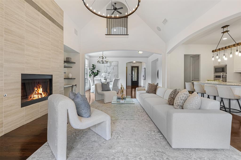 This stunning end-unit townhome in the gated section of Castle Hills offers a luxurious, lock-and-leave lifestyle with access to a private community pool and fire pit area. Inside, you'll find hand-scraped wood floors, soaring cathedral ceilings, decorative light fixtures, and abundant natural light from large windows. The gourmet kitchen features granite countertops, stainless steel appliances, a 6-burner gas range, double oven, and a center island with pendant lighting. The spacious primary suite includes a bay window sitting area, jetted tub, separate shower, and access to the laundry room. Entertain in the game room with a sliding barn door or in the fully equipped media room. The low-maintenance backyard boasts a covered patio, wood decking, and grassy area for pets. Conveniently located within walking distance of tennis and basketball courts, an amenity center, and the Village Shops, this home offers both luxury and convenience.