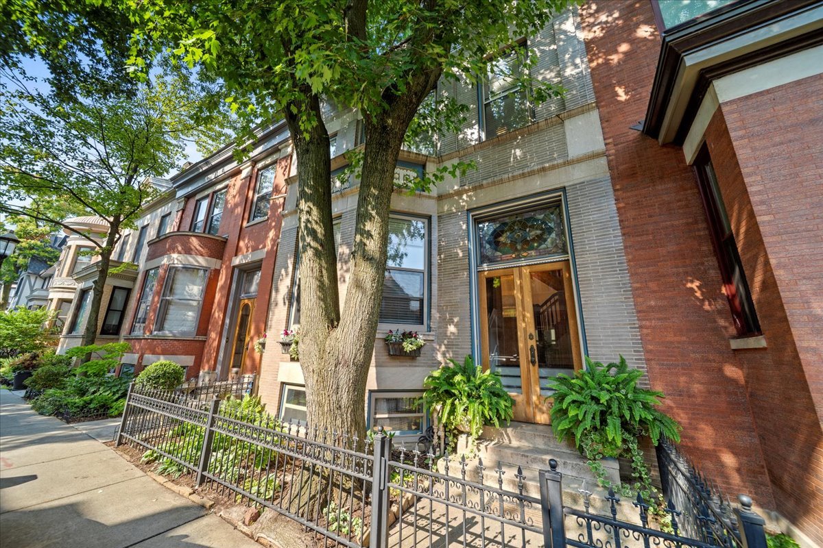 MULTIPLE OFFERS RECEIVED - HIGHEST & BEST OFFERS BY  MONDAY 08/11 - 12NOON PLEASE. Beautiful, amazing and gorgeous rowhome in highly sought after iconic and prestigious Alta Vista Terrace Historic District, rich in Chicago history, and rarely on the market! Situated on the preferred West side of Alta Vista this wonderful 3 bedroom/2.5 bathroom home boasts 3 levels of living space with plus parking! Large inviting front foyer entry with hardwood floors and crown molding throughout. Main level includes the spacious living room, wood burning fireplace, dining room with built-in hutch, updated light & bright Cook's kitchen with bump-out/add-on extension (2021) featuring all custom finishes: cabinetry, backsplash, countertop, high-end stainless steel appliances (Viking cooktop with vent hood, Monogram oven, microwave, refrigerator, dishwasher, beverage fridge), double sink and wall mounted pot-filler faucet. Charming outdoor patio area access from Kitchen rear door. Spectacular 2nd level space includes Primary Bedroom with spa quality ensuite bathroom (double vanity, designer tilework & light fixtures, aroma steam shower) and custom closets + 2 additional bedrooms and an additional full bathroom. Fully finished lower level perfect for entertaining and everyday needs with fabulous recreation room (new floors and paint in the last 6 months) with custom built bar featuring custom cabinets, full-size refrigerator + beverage fridge plus half bathroom and additional office space, wine cellar, workshop and fully appointed laundry room with side-by-side washer/dryer, laundry sink, cabinet storage with folding area. All bathrooms and mechanicals (HVAC, A/C compressor, coil, water heater, heat pump and washer/dryer) redone/updated and replaced within the last 5 yrs. Tuckpointing 7 yrs. Exterior front and back painted and sealed 5 yrs.  Easy access to shopping, public transportation Red Line CTA Sheridan stop and buses, restaurants, coffee shops, Kelly Park walking path and steps from Wrigley Field. Make this marvelous home and piece of history on the best block in Chicago yours now!