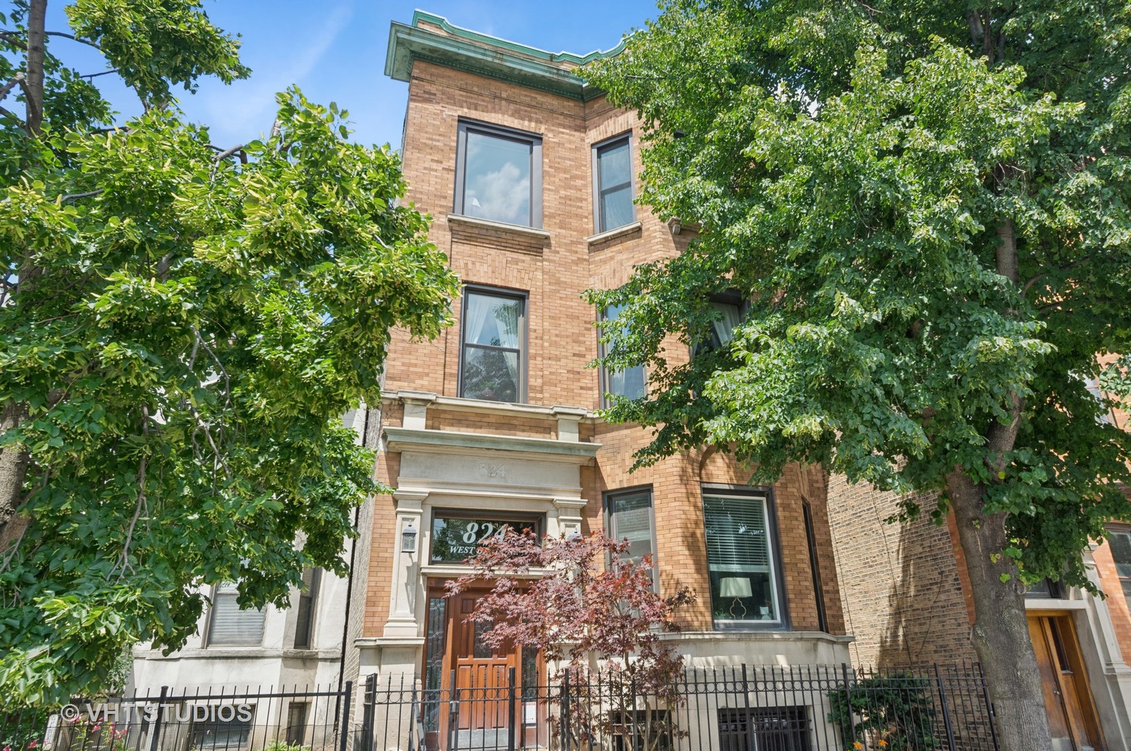 Top floor unit in classic East Lakeview 3 unit brick building on beautiful tree lined Dakin St. This 3 bedroom/2 bath home is filled with natural light and is a perfect mix of vintage and contemporary details with hardwood floors, huge windows and a wood burning fireplace. The wide open floorplan is a fabulous entertaining space flowing from living/dining room to the kitchen.The gorgeous renovated kitchen has quality cabinetry, large island with quartz and designer kitchen details. Both bathrooms renovated with great details and built-in storage.  Large back deck overlooking common backyard, in unit washer/dryer, garage parking,  an extremely well maintained building, all make this a very special home. Awesome location close to lake, public transportation, Gill Park, restaurants  and of course Wrigley Field.