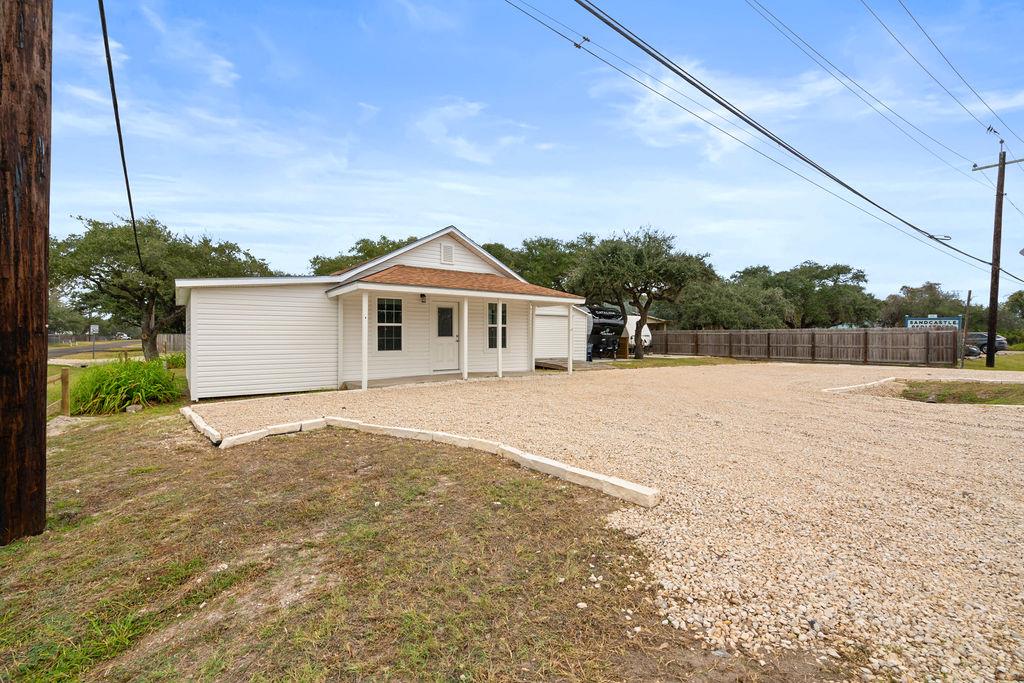 Wonderful opportunity! 5 R/V spots with Electric, water and septic. ALSO- a club house or residence or another business ADDITIONALLY a storage building.  Create a little business center at this very busy corner location. A cute little RV park with a space for a business. Guests can enjoy a meal under the community pergola.