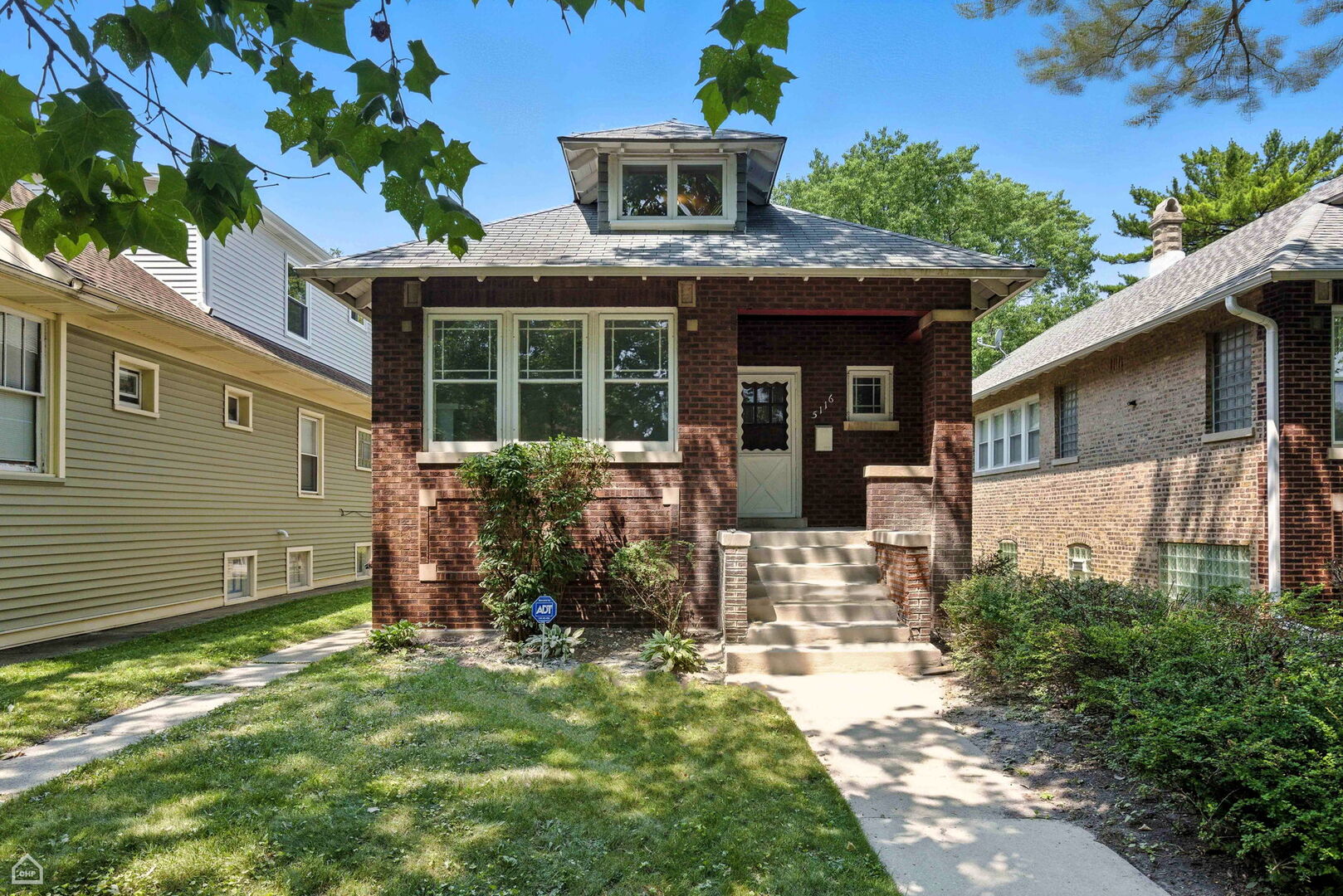 Welcome to this stunning historic Chicago brick bungalow, perfectly situated on a tree-lined street on a rare extra-wide lot. Step inside and you'll be charmed by original wood built-ins and elegant hardwood floors that flow seamlessly throughout, beautifully blending timeless character with modern updates. The updated kitchen is a culinary enthusiast's dream, complete with stainless steel appliances, abundant counter space, and a functional layout ideal for entertaining. The main level offers two comfortable bedrooms and a full bathroom with a bright, airy design. Upstairs, you'll find an additional bedroom and a den, providing flexible living space to suit your needs.  The unfinished basement is an open canvas, ready for your ideas and customization. Enjoy being close to numerous parks, including Eugene Park and River Park, offering walking and biking trails, a kayak and canoe launch, soccer fields, basketball and tennis courts, baseball fields, a dog park, and swimming pools.  Large yard and a 1 car garage.  Home features Gas forced heat and central AC.