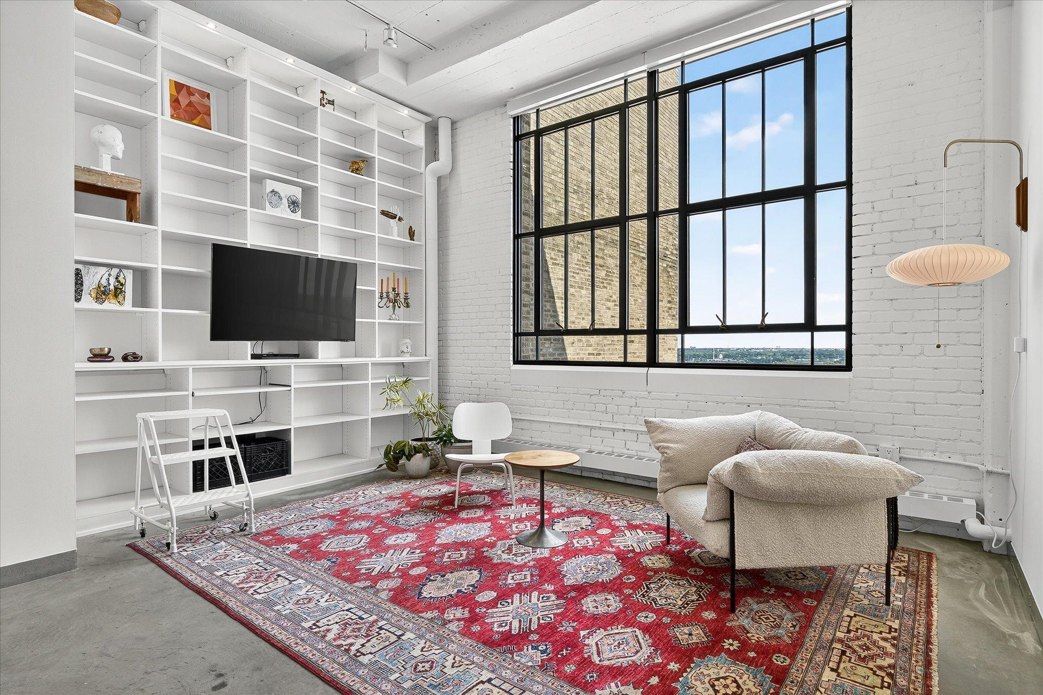 Private underground parking, sleek one-level loft living at Chicago Condos in the historic Midtown Exchange building. Drive in, take the elevator home to a stunning freshly painted 12th-floor loft which boasts 12’ ceilings, exposed brick, and large windows with breathtaking East views. The modern features a custom island, stainless steel appliances, granite countertops, and luxurious lighting upgrades. Benefits include concrete flooring, in-unit laundry, a basement storage unit, and 1 private underground parking space.
Unwind in the theater/media room, stay fit in the gym, or host gatherings in the rooftop community room with a patio, grill, seating, and resident planter boxes. Step into the vibrant Midtown Global Market downstairs for a variety of restaurants, shops, and entertainment.
Enjoy the Midtown Greenway trail at the end of the block and Powderhorn Park just 2 blocks away. With 24-hour security, seamless one-level living, and easy access to freeways and public transportation, you'll love kitchen the convenience and lifestyle offered. Pets are welcome in this magnificent property!