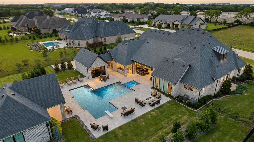 Welcome to this magnificent J. Anthony estate home, perfectly nestled on over an acre of beautifully landscaped grounds. This stunning residence boasts exquisite designer finishes throughout, reflecting a level of craftsmanship that is truly unparalleled. The open & airy floor plan primarily offers one-story living, with an expansive layout that includes a private upstairs bedroom suite.The heart of the home features a chef's dream kitchen, equipped with high-end appliances & custom built-ins, perfect for culinary enthusiasts & entertainers alike. The living spaces flow effortlessly into the outdoors, where you'll find a gorgeous and large pool, providing the ultimate in relaxation. Accommodating guests is a breeze with the inclusion of a full guest house & separate nanny quarters, ensuring privacy & comfort for everyone. Car enthusiasts will appreciate the impressive 5-car garage, offering ample space for vehicles and storage.This custom-built home is the epitome of luxury living.